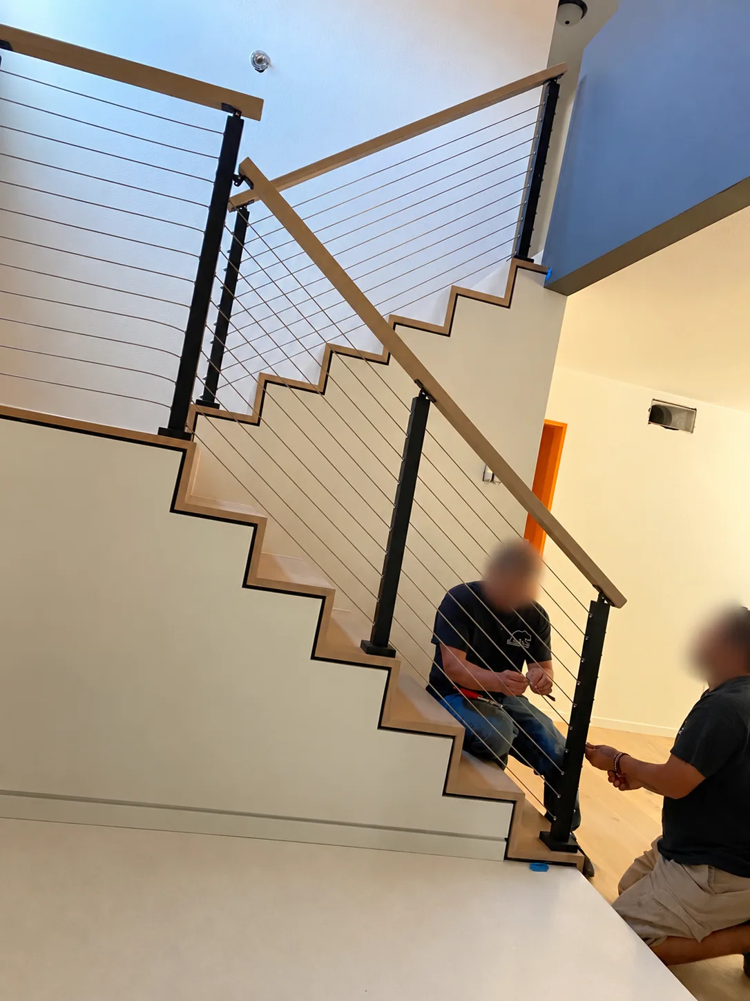 Crew fitting the cable rail on the white oak stair in Agoura Hills