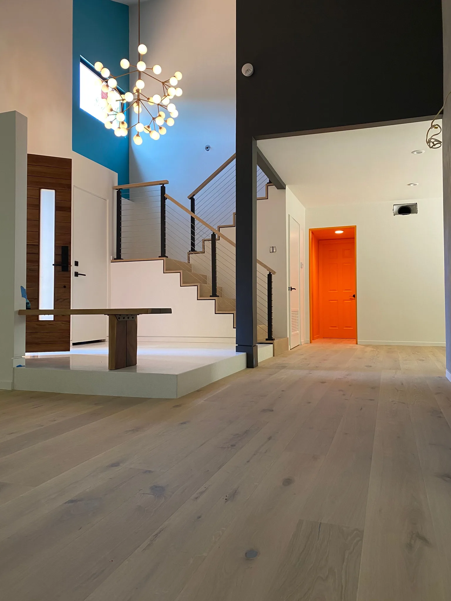 Wide-plank white oak through the entry hall to the cable-rail stair in Agoura Hills