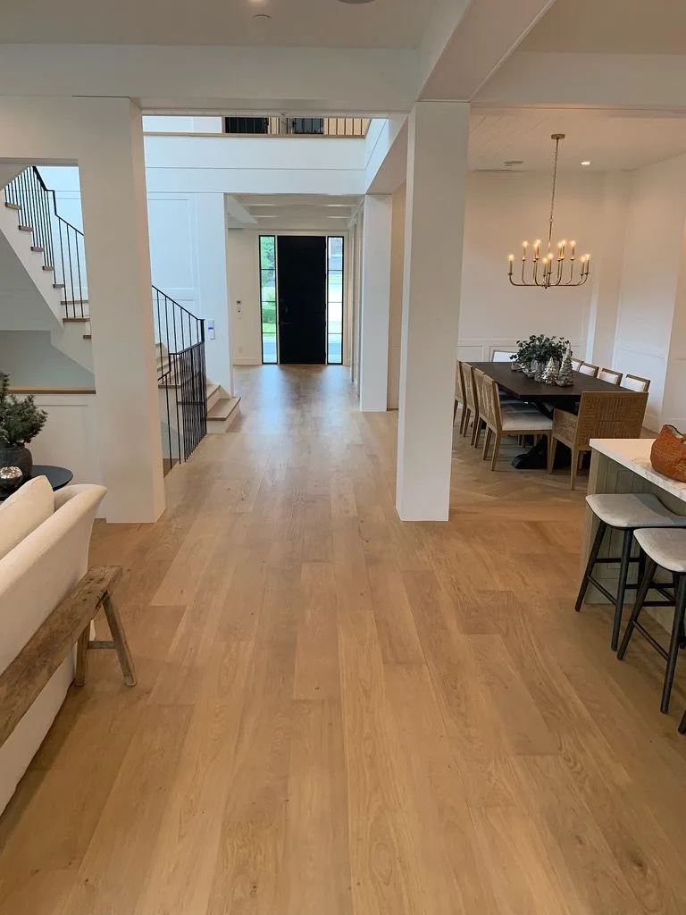 White oak running from the entry to the dining room, stair rising at left in Manhattan Beach