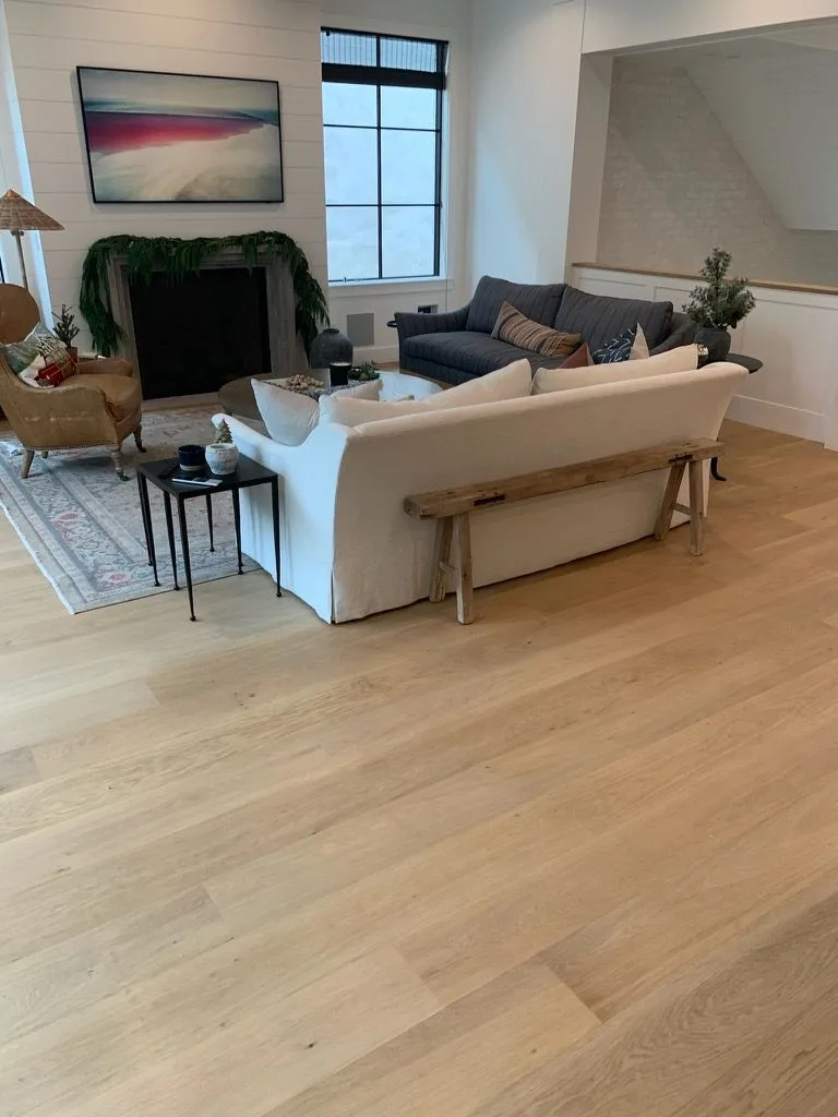 Wide-plank white oak in the living room, fireplace and sectional in Manhattan Beach
