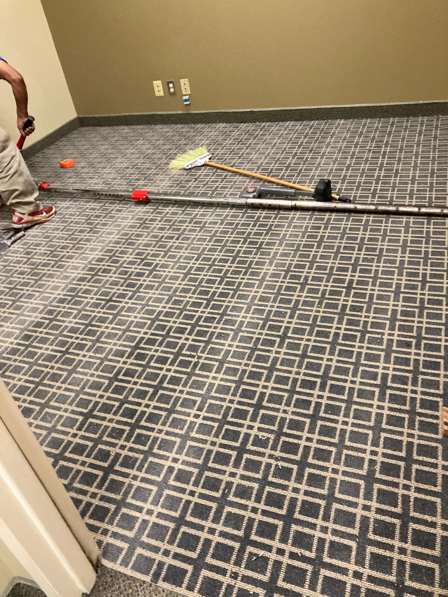 Grid-pattern carpet power-stretched wall to wall over pad