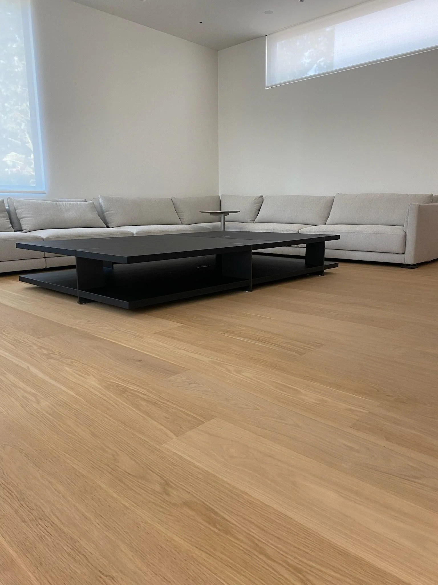 10-inch oak planks under a long sectional and low table in Santa Monica