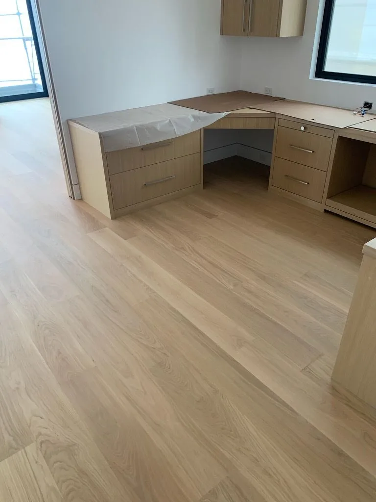 Wide-plank white oak under a built-in oak desk and cabinetry in Redondo Beach