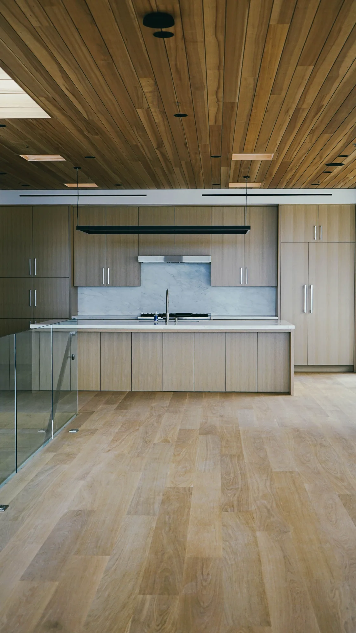 Wide-plank white oak through a kitchen with oak cabinetry and a cedar ceiling in Redondo Beach
