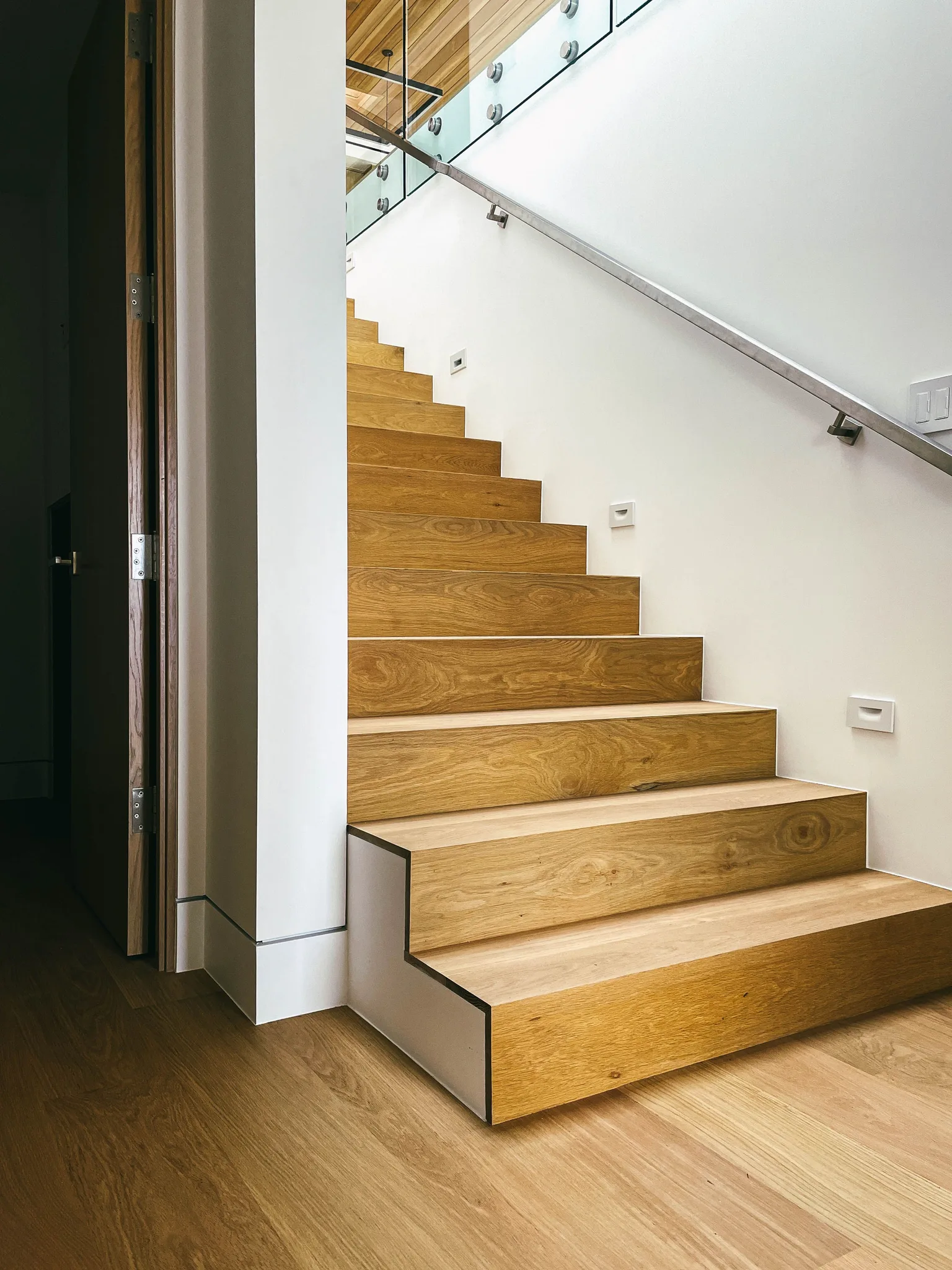 Straight run of white oak stairs with closed risers turning at the landing in Redondo Beach