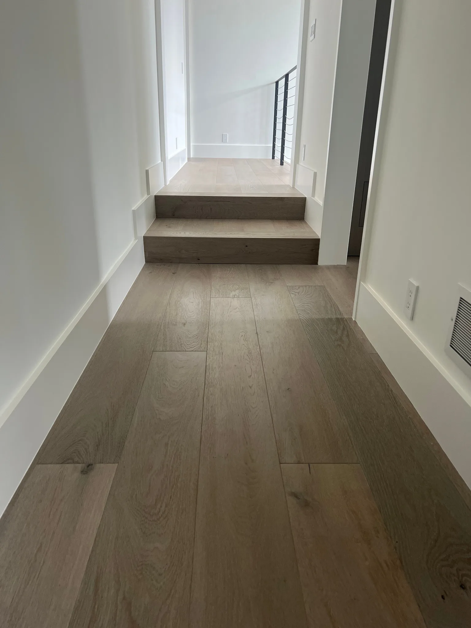 Oak waterfall steps leading to hallway