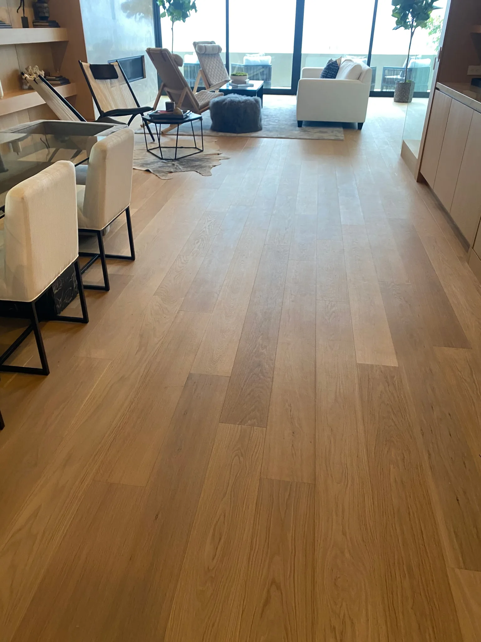 Wide-plank oak through an open living and dining room