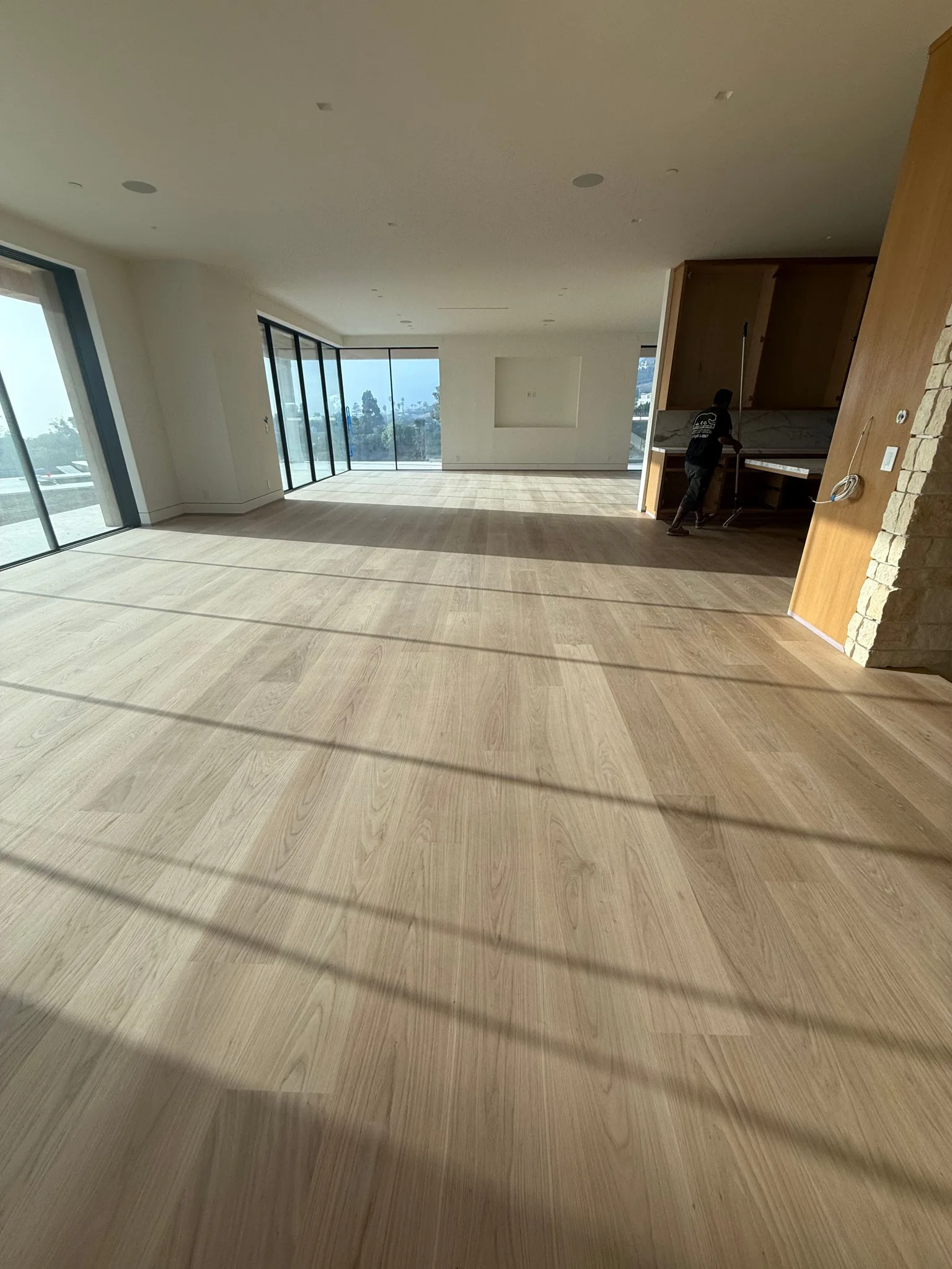 Pale wide-plank oak in a matte finish across an open-plan floor