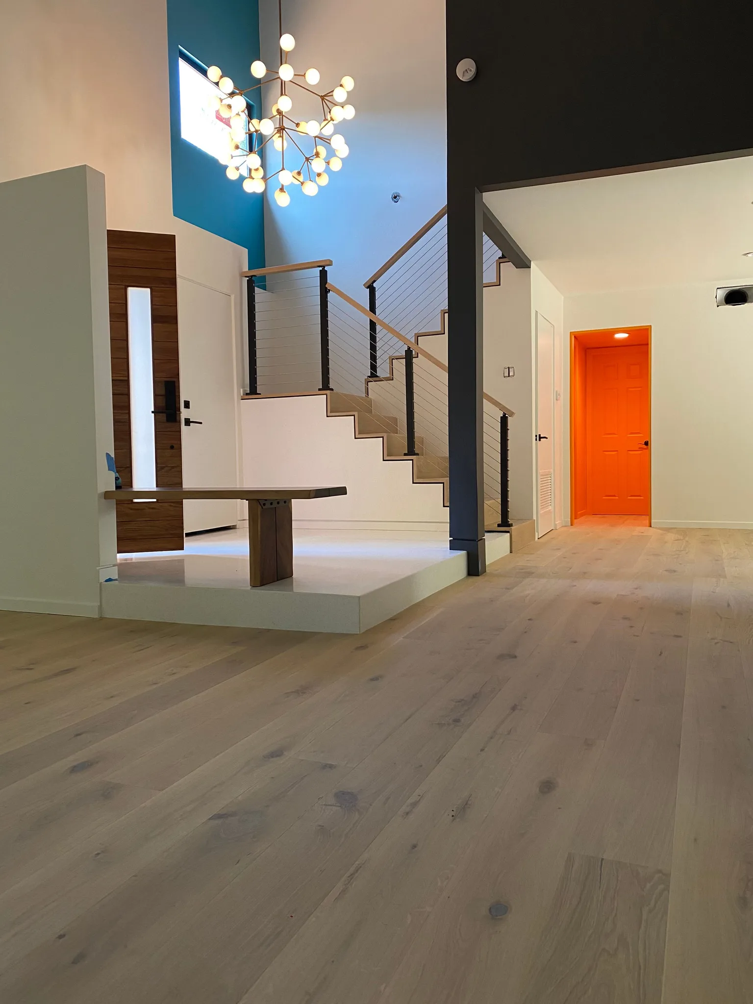Character oak flooring with waterfall staircase under a cable rail