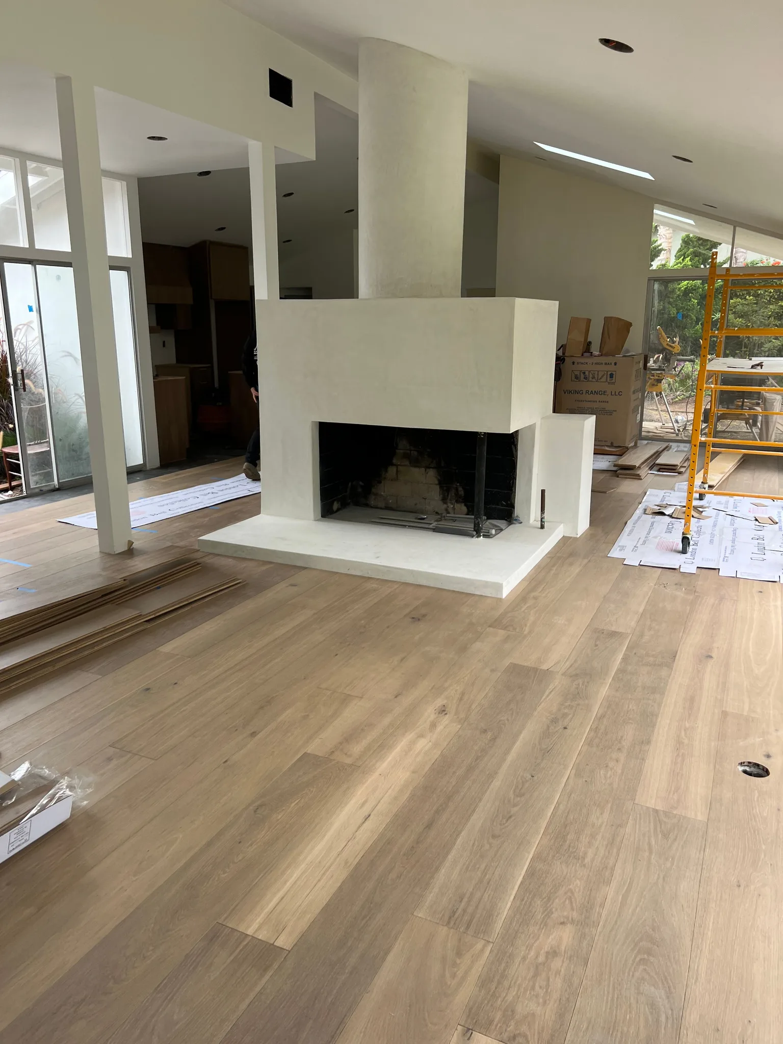 Wide-plank oak around a plaster fireplace