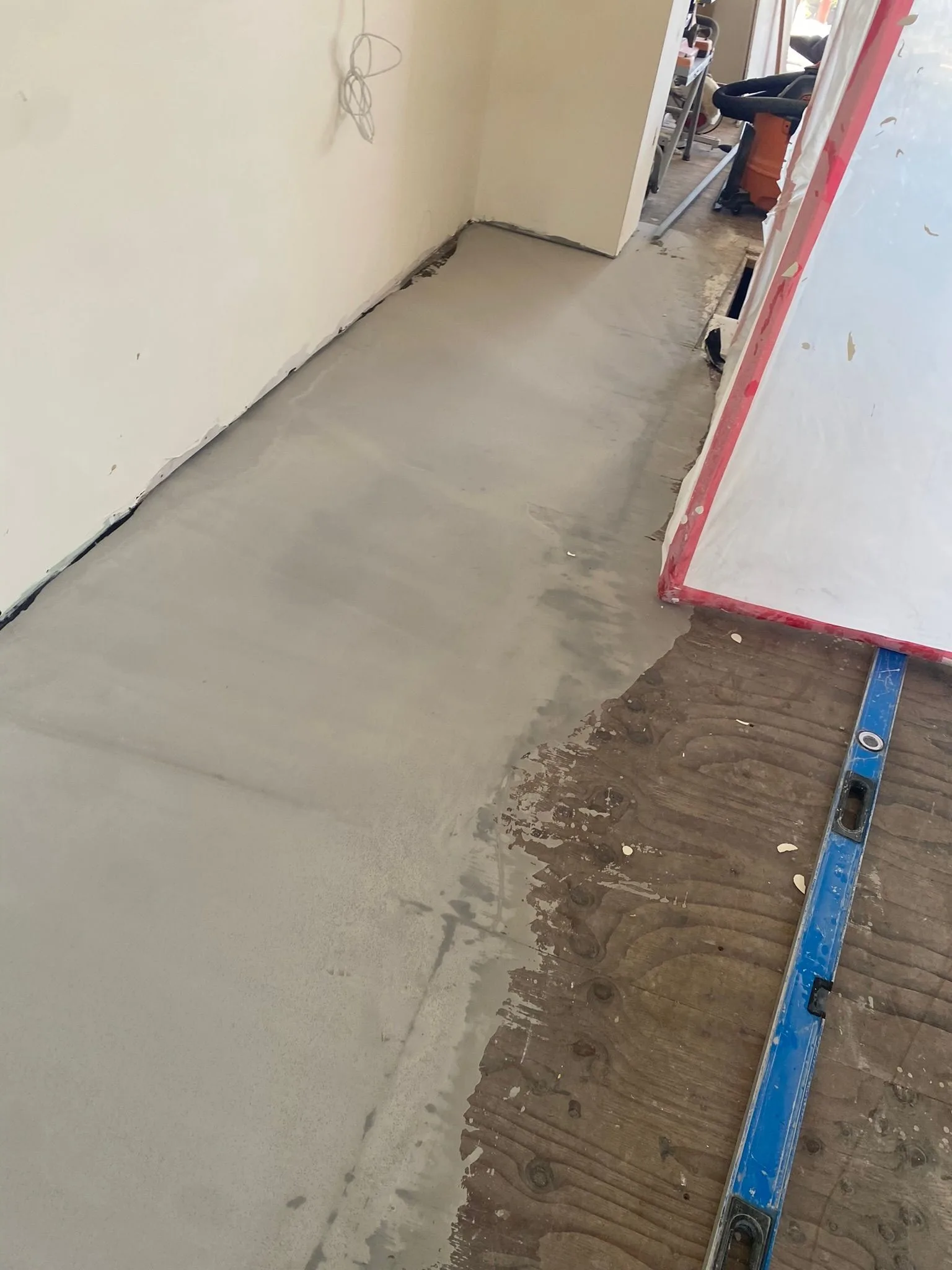 Leveling compound cured flush with the plywood it corrected