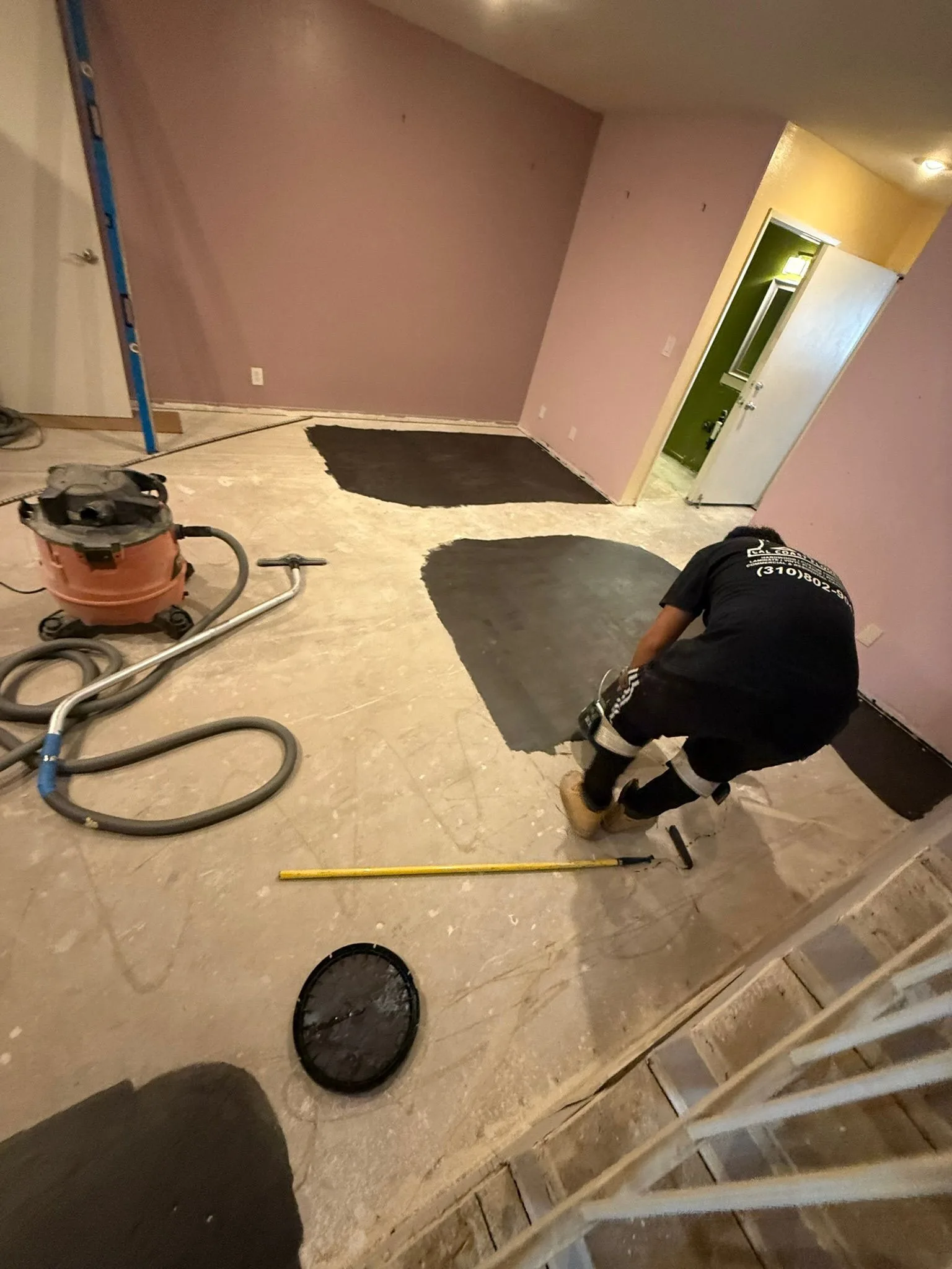 Rolling primer onto a subfloor before leveling