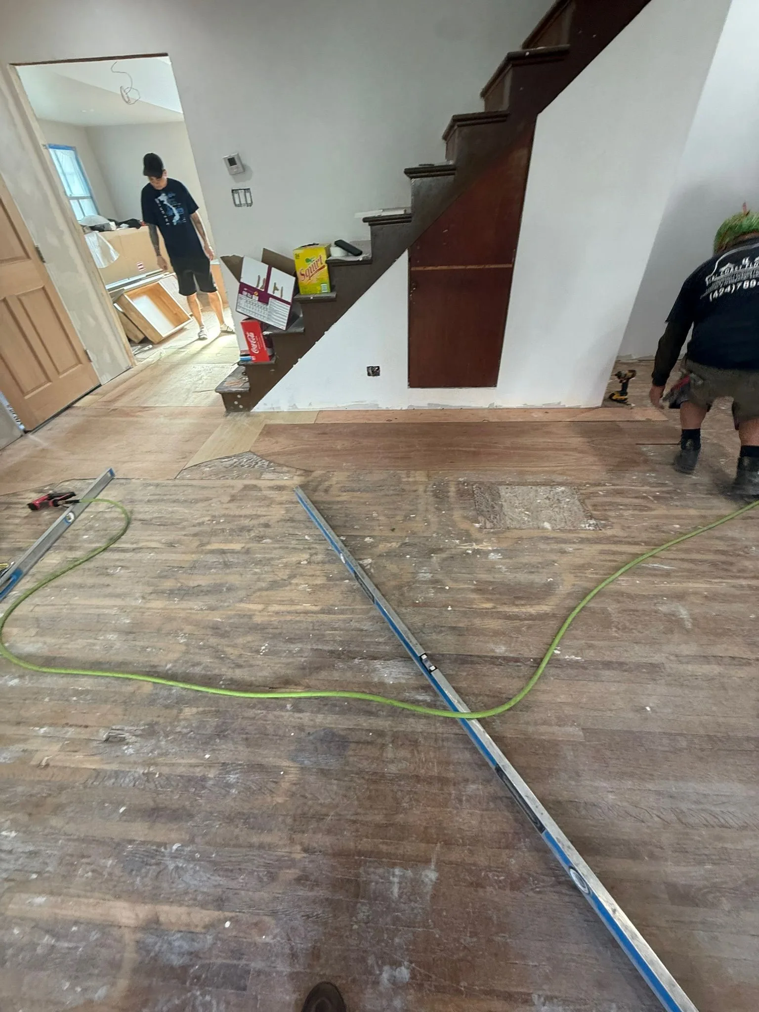 Old plank subfloor checked with a long level before correction