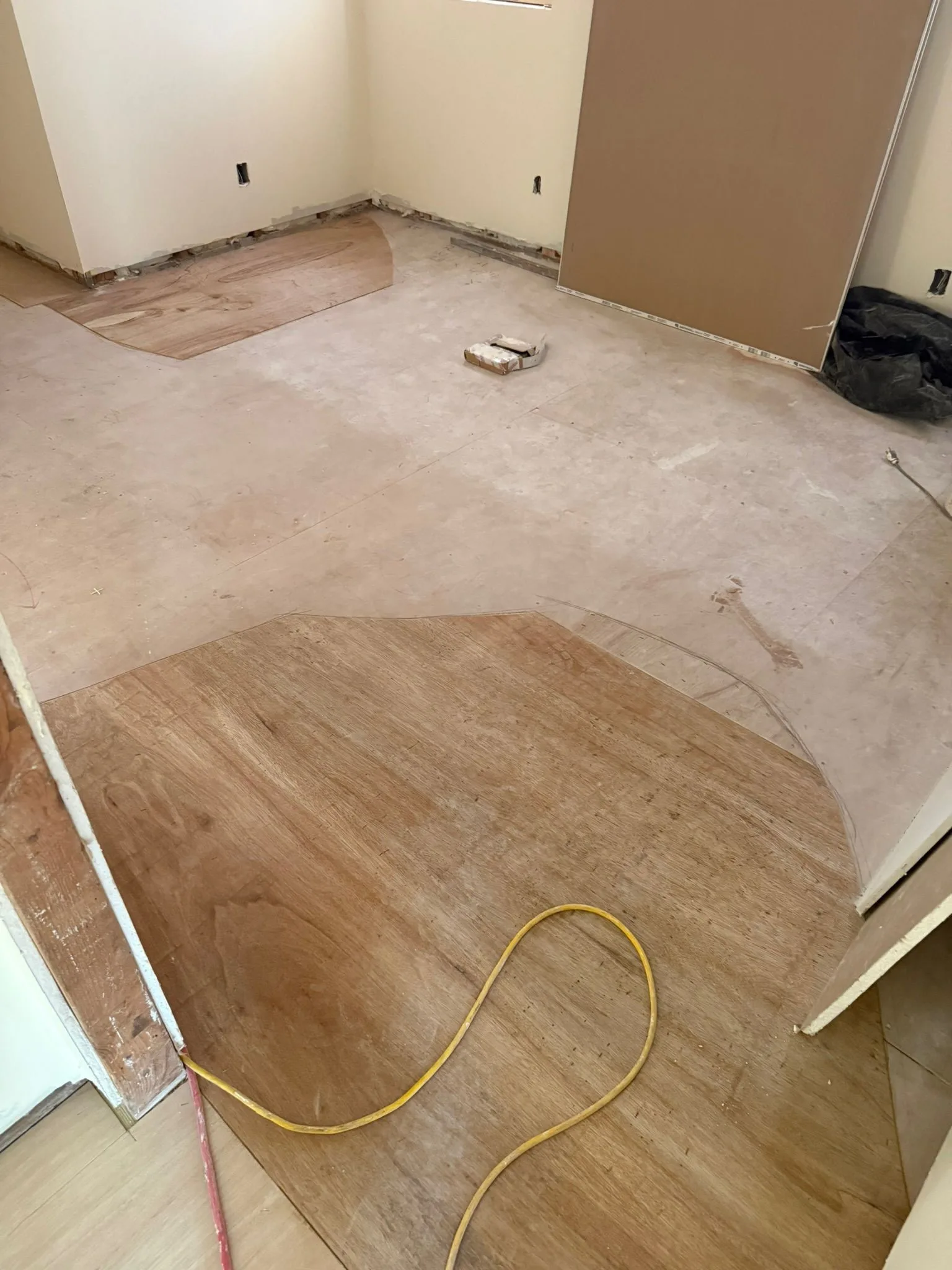 Tapered plywood patches building up low areas of a subfloor