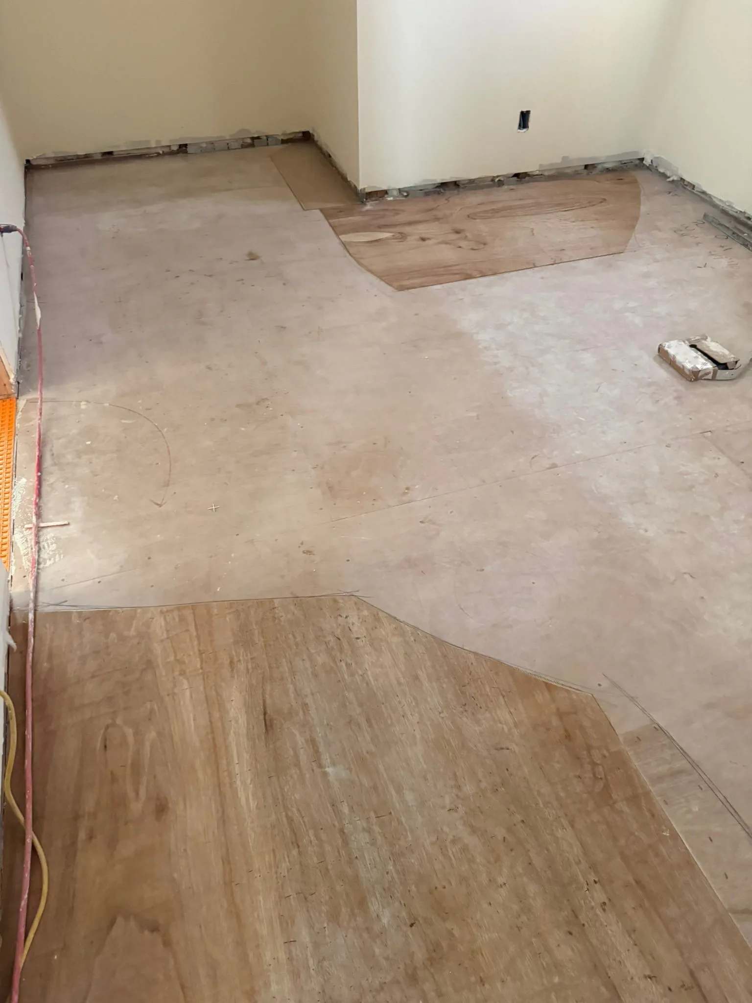 Plywood correction patches across a bedroom subfloor