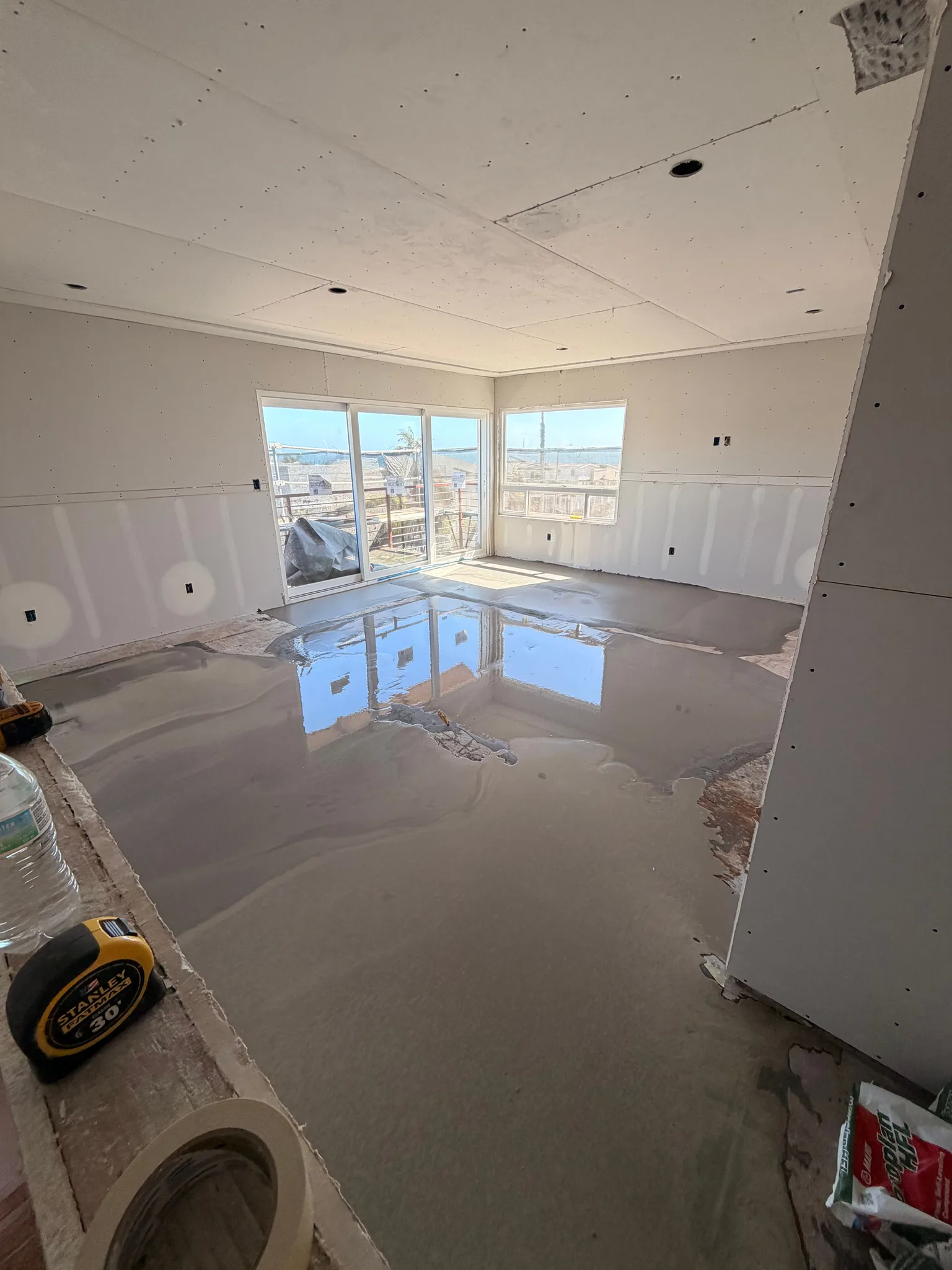 Self-leveling pour in a room with an ocean-view slider