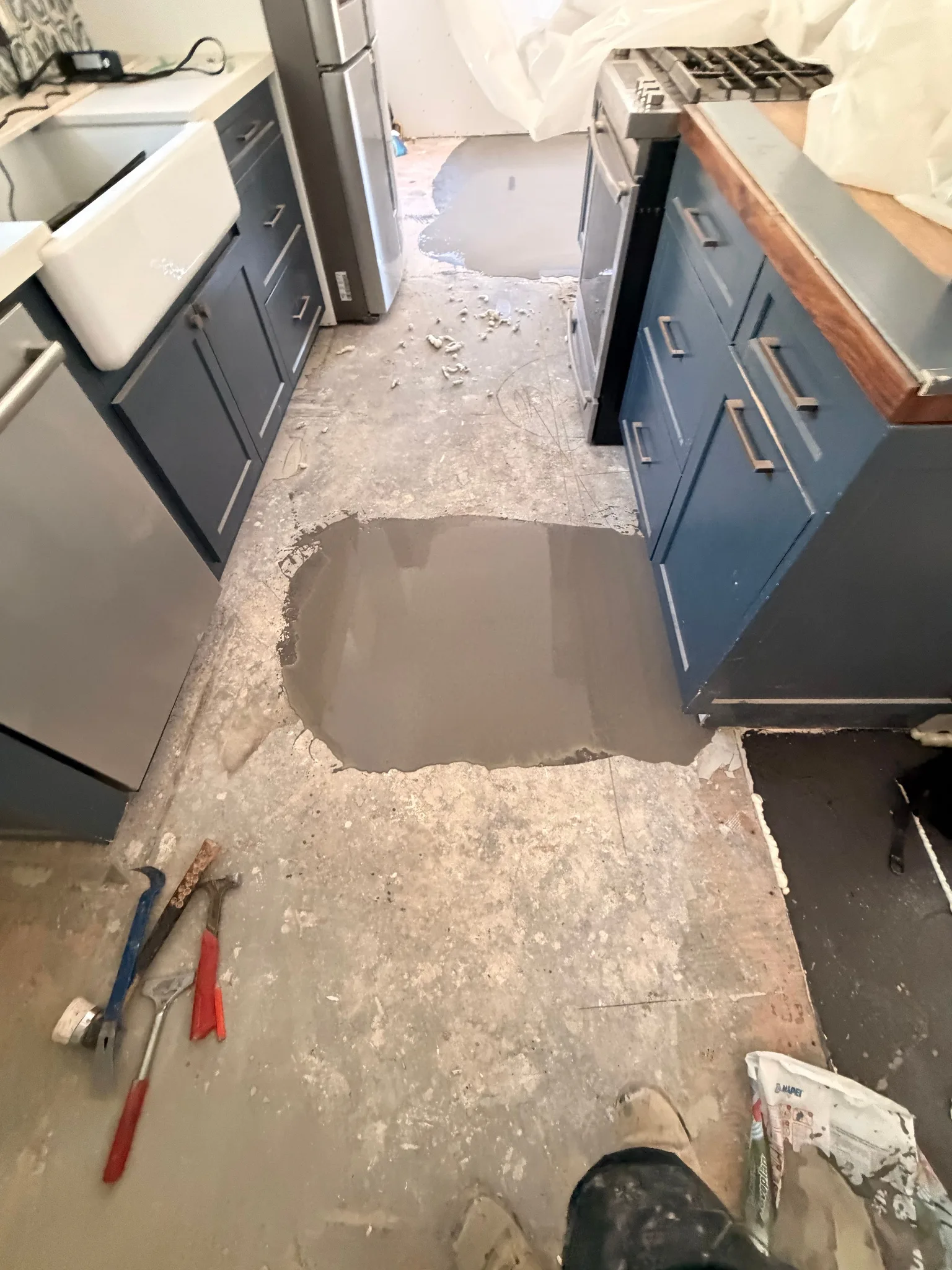 Self-leveling compound poured into a low spot on the kitchen subfloor