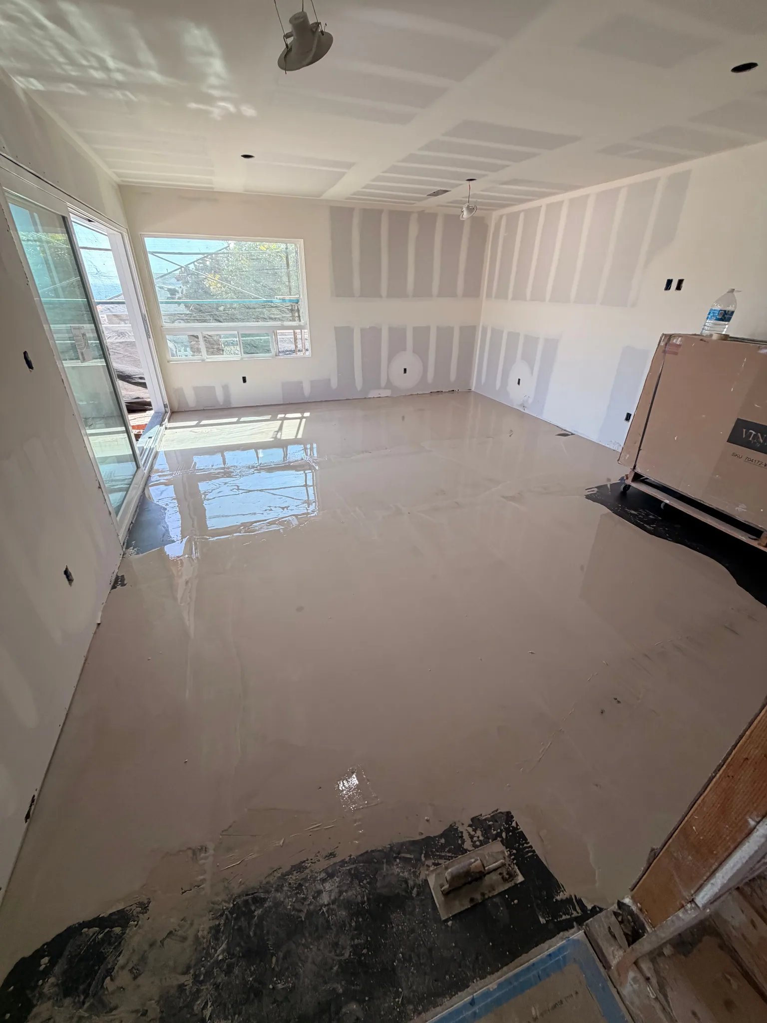 Leveling compound poured wall to wall over a primed subfloor