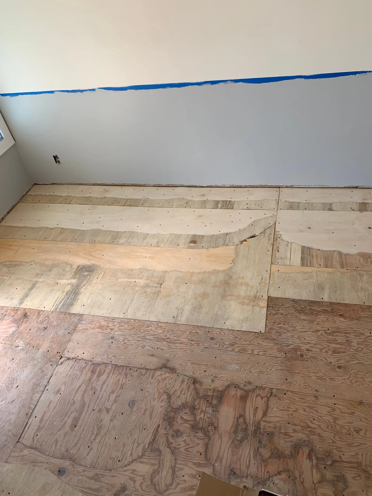 Plywood overlay patches feathered into an old subfloor
