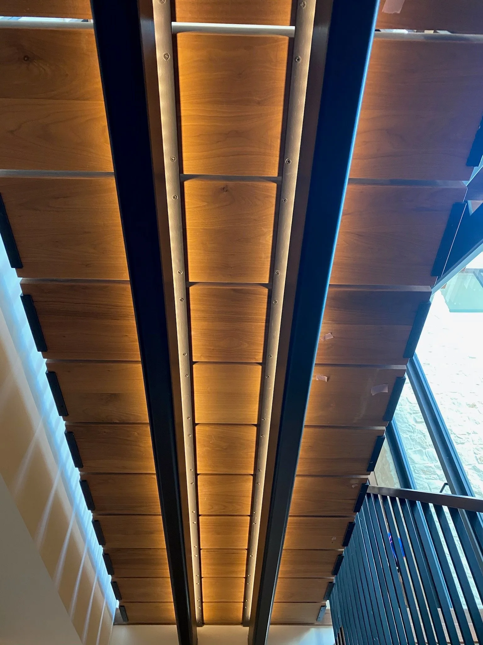 Underside of the floating walnut treads, lit from the wall in Hermosa Beach
