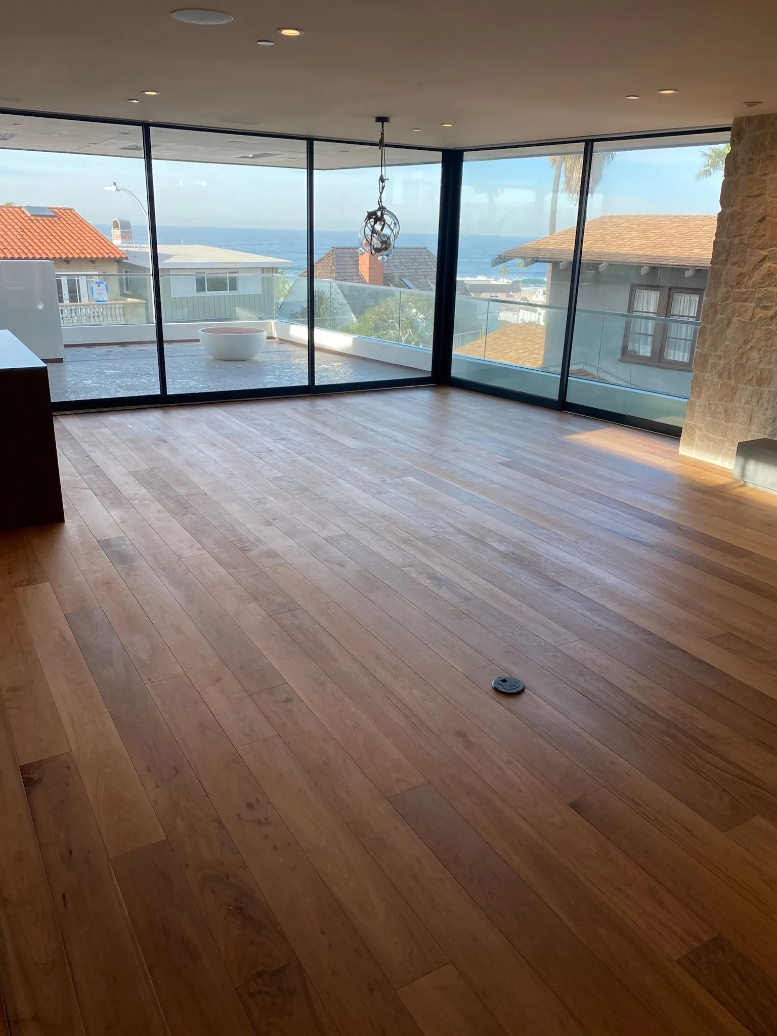 7-inch walnut planks through the living room toward the view in Hermosa Beach