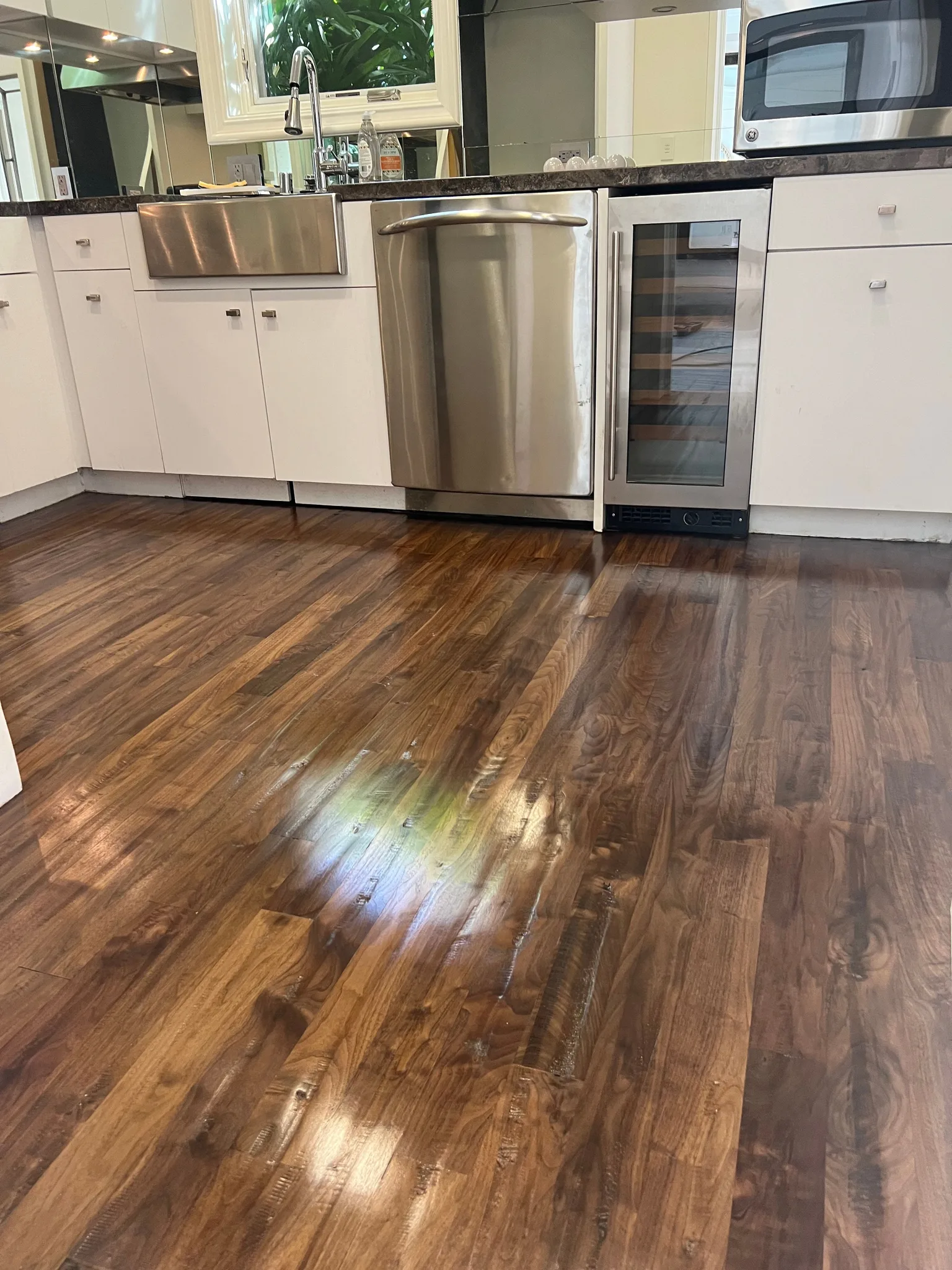 Hand scraped walnut with a gloss finish through the kitchen