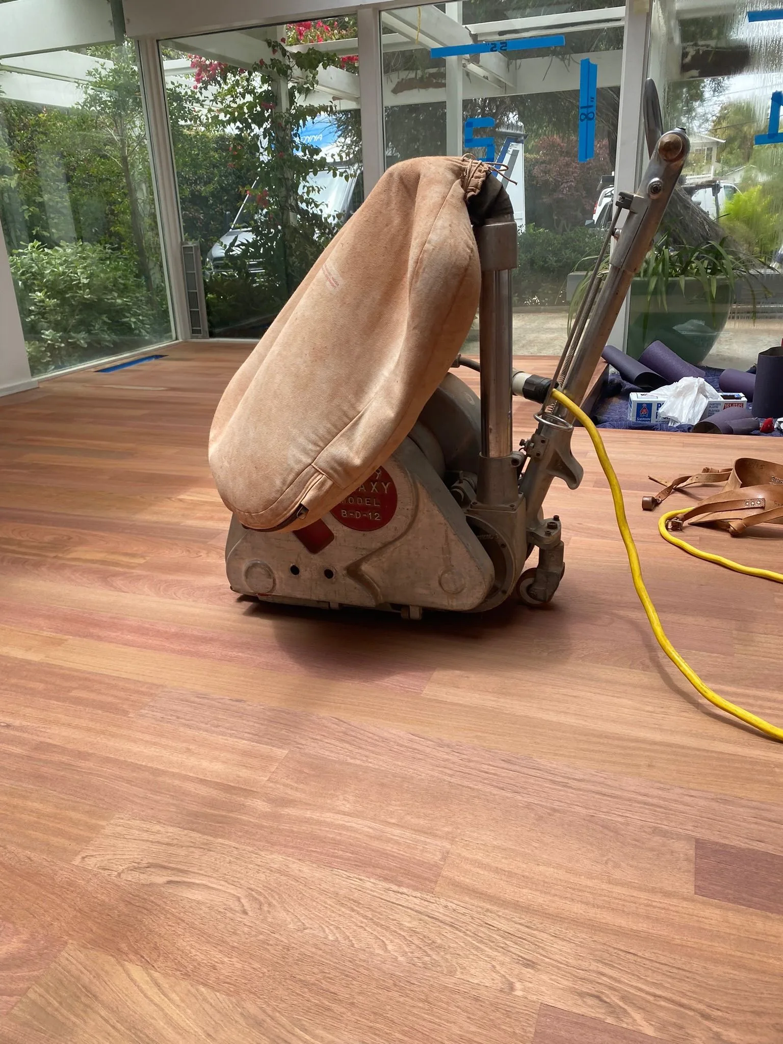 Raw red-toned hardwood after the final sanding pass
