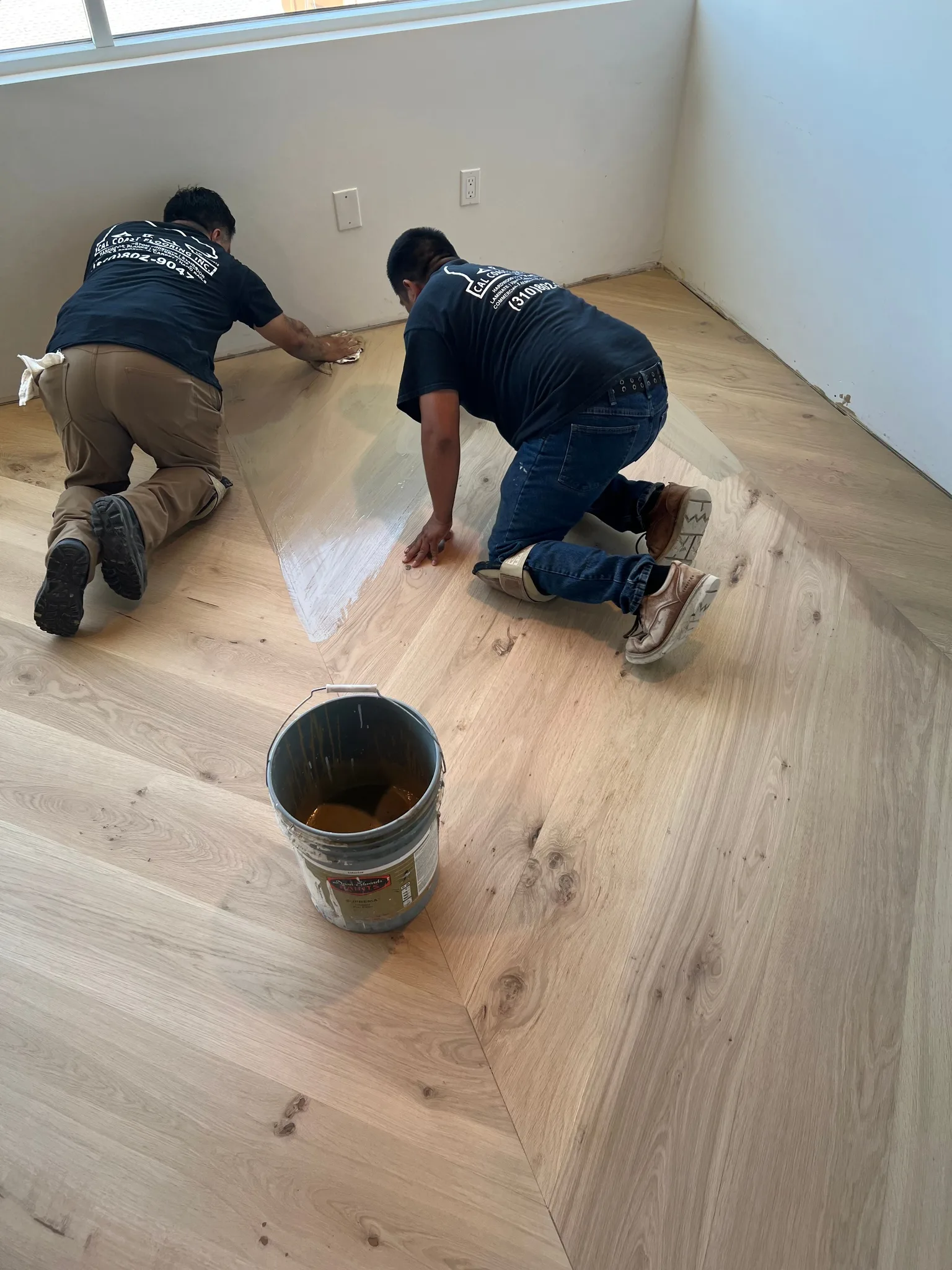 Cal Coast crew applying custom mixed stain to chevron design on Pacific Coast Highway