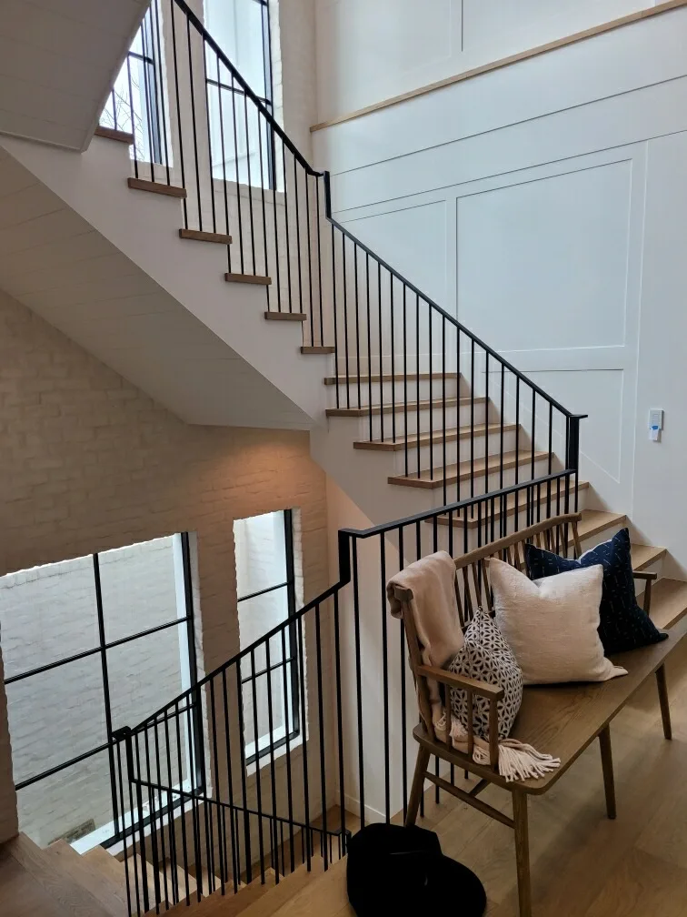 Oak treads and white risers with a black steel railing