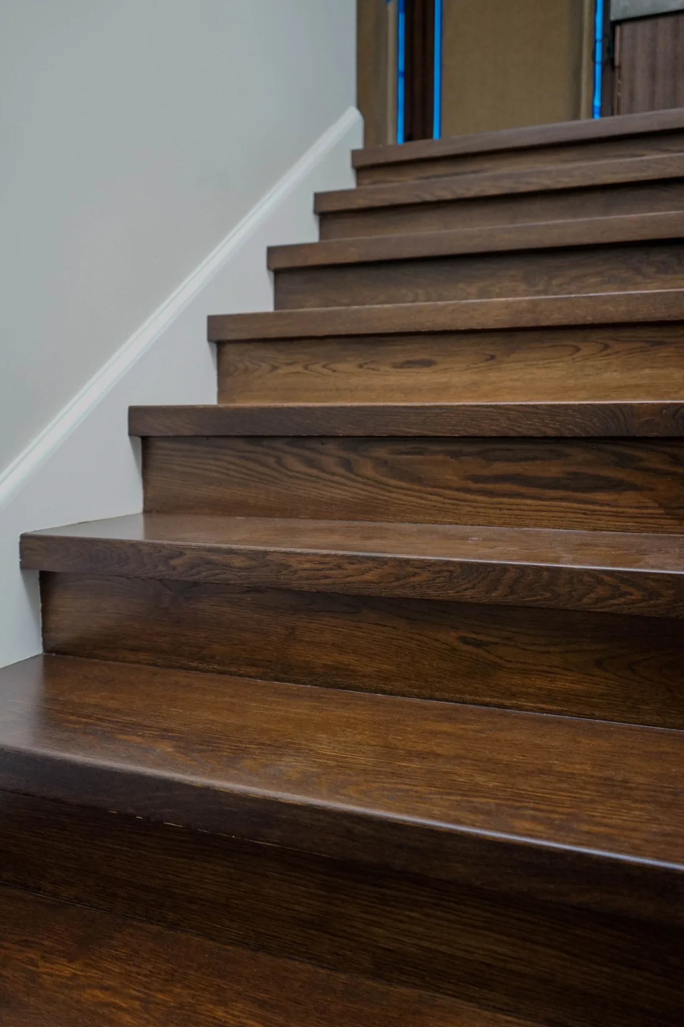 Oak treads and risers in a deep brown stain in Manhattan Beach