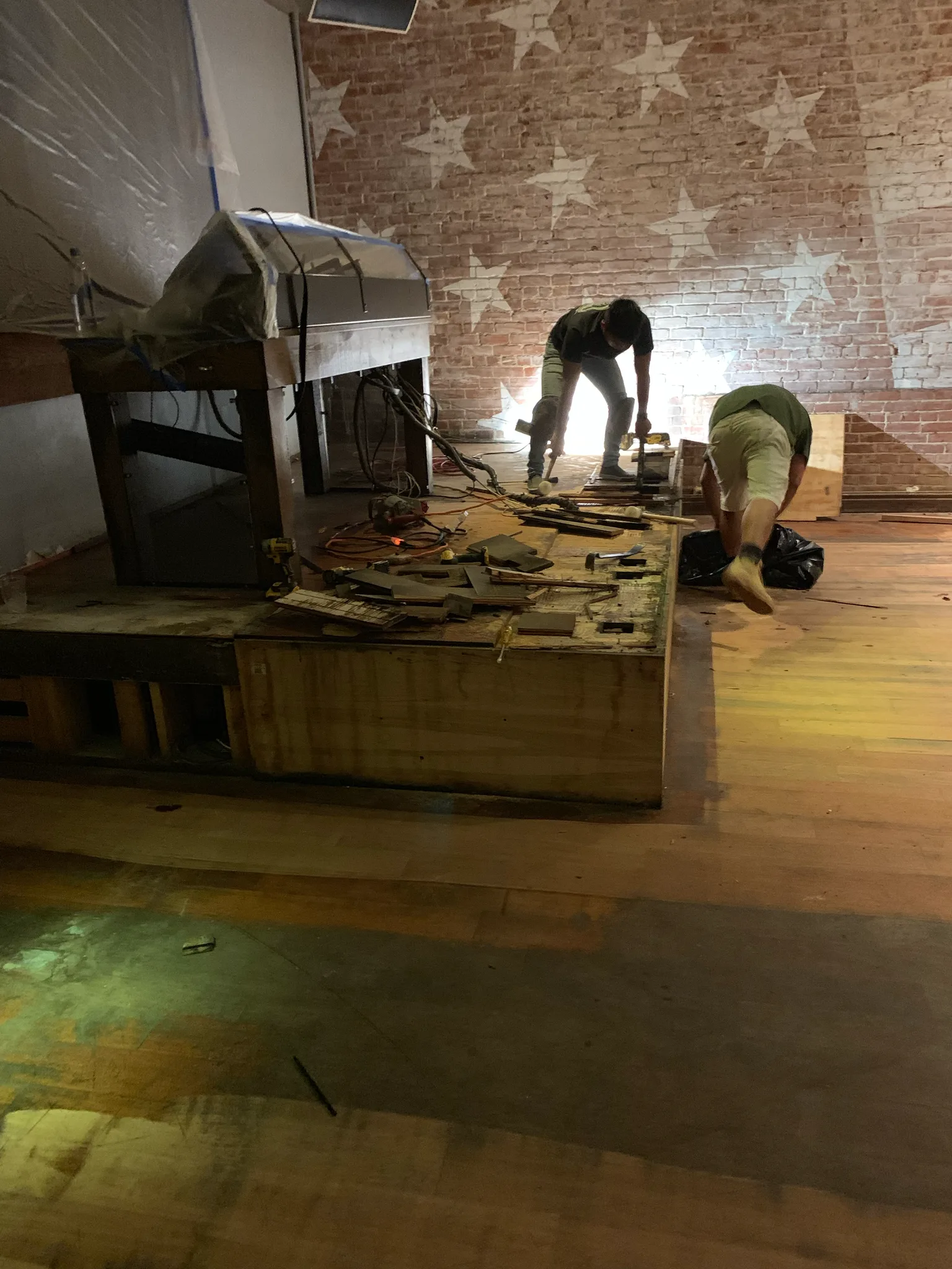 Work in progress: Cal Coast Flooring crew working around the bar platform at American Junkie