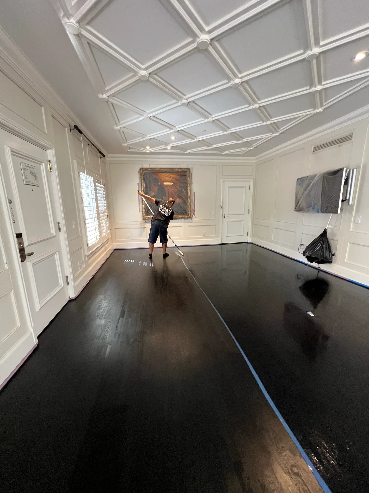 Work in progress: dark stain going onto the hardwood floor of a coffered-ceiling room at The Beverly Hills Hotel