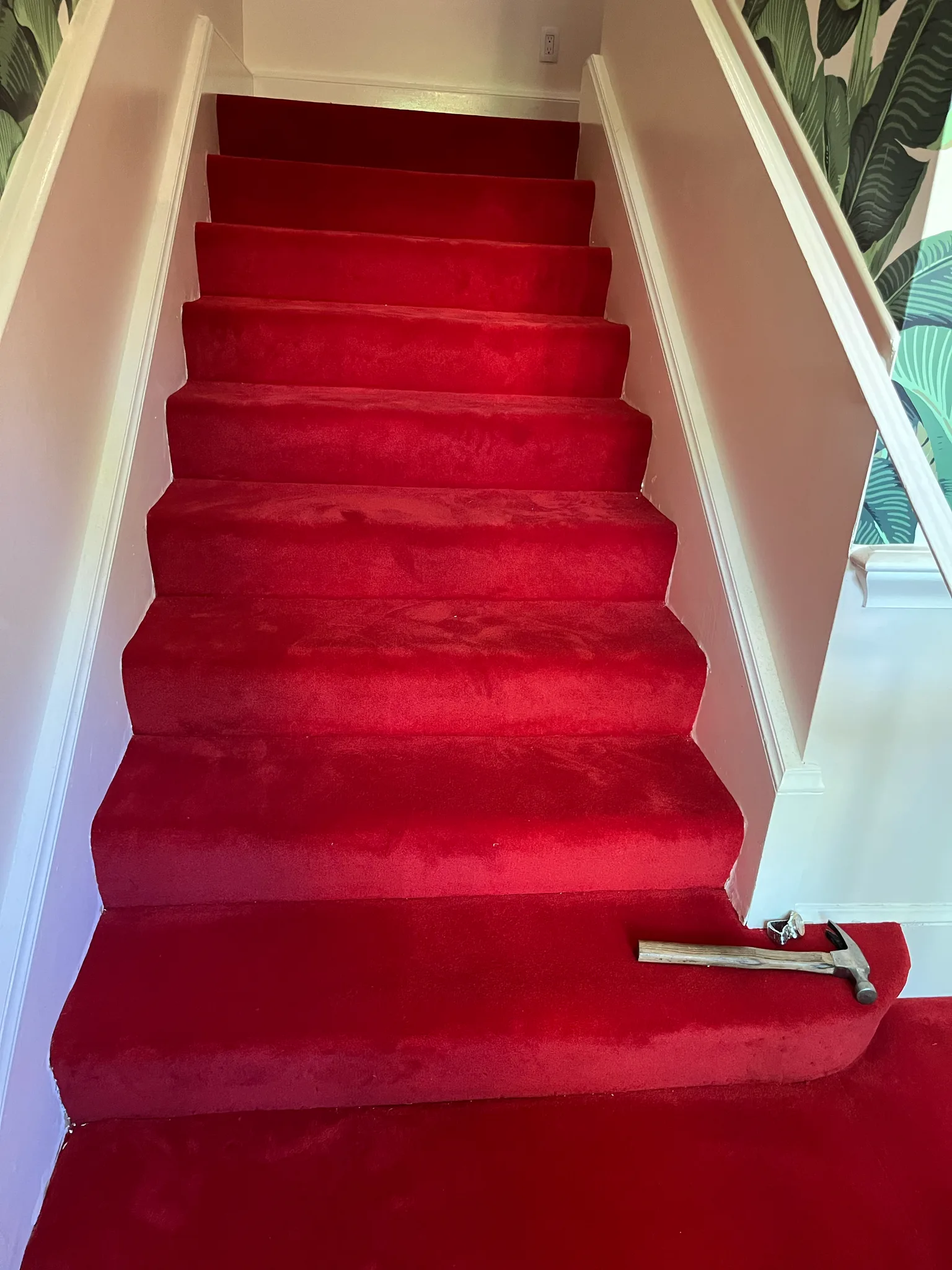 Work in progress: red carpet stair runner being fitted on a staircase at The Beverly Hills Hotel