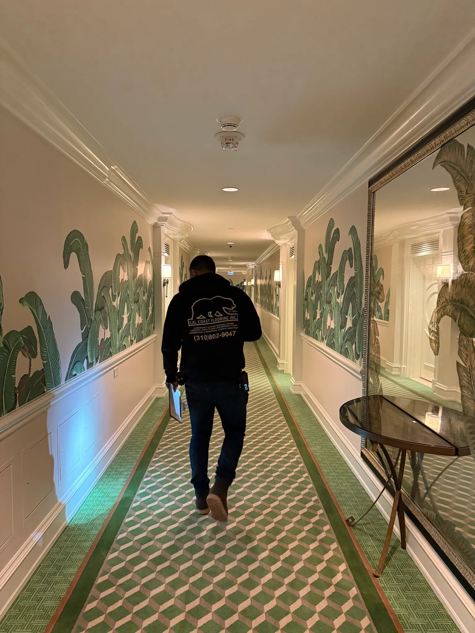 Cal Coast Flooring crew member on the new green diamond-pattern corridor carpet at The Beverly Hills Hotel