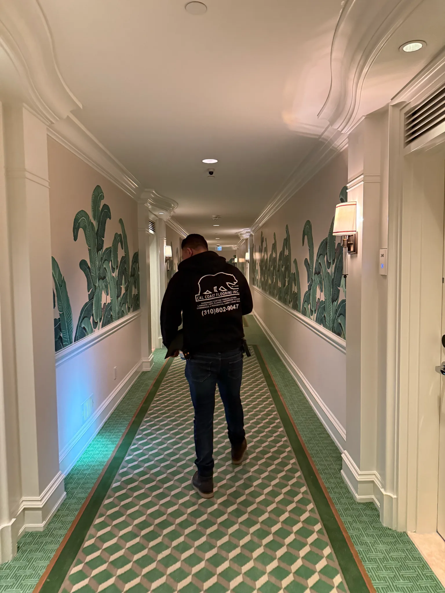New green geometric corridor carpet running past guest-room doors at The Beverly Hills Hotel