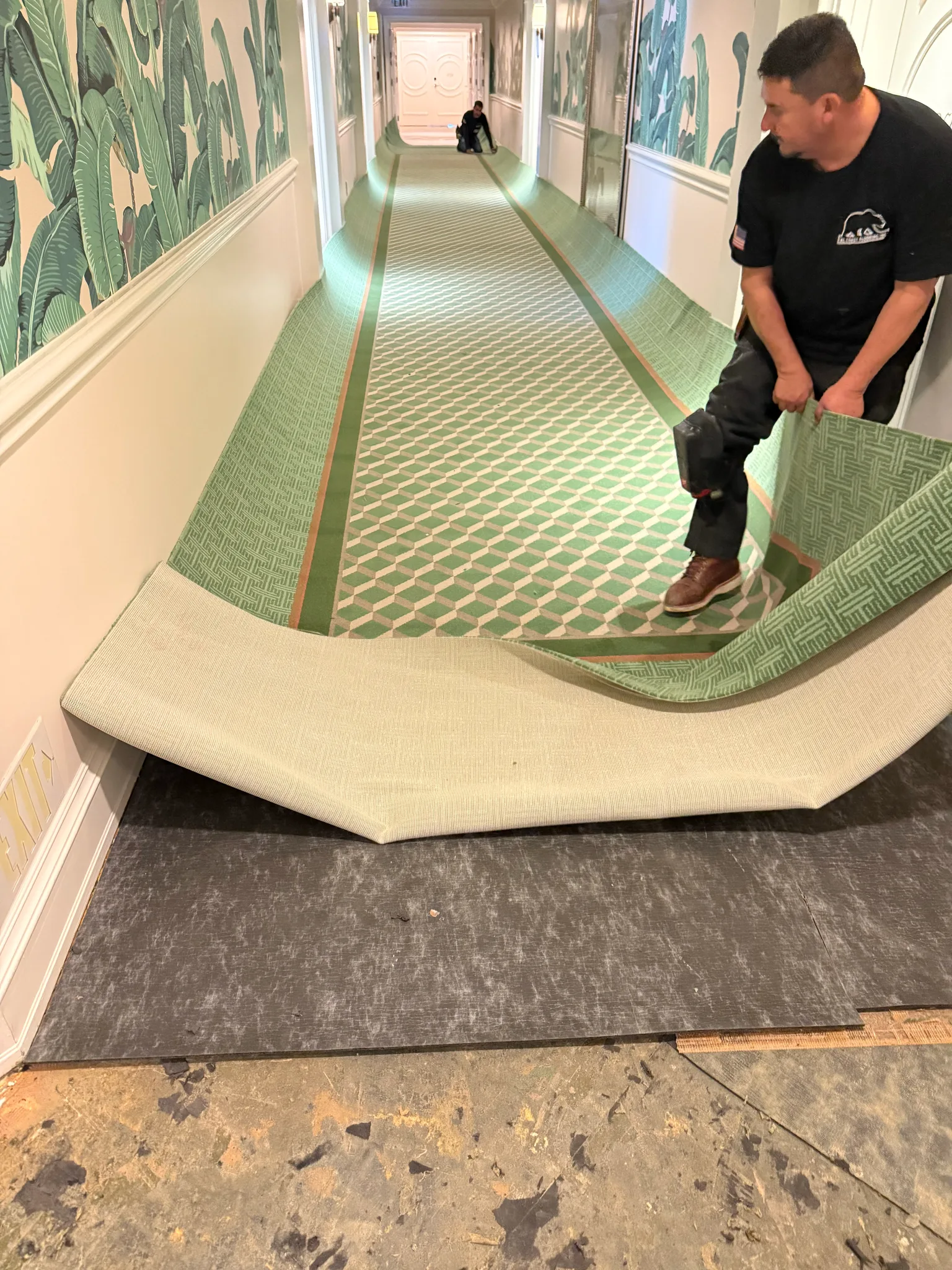 Work in progress: crew rolling out new green corridor carpet over fresh underlay at The Beverly Hills Hotel
