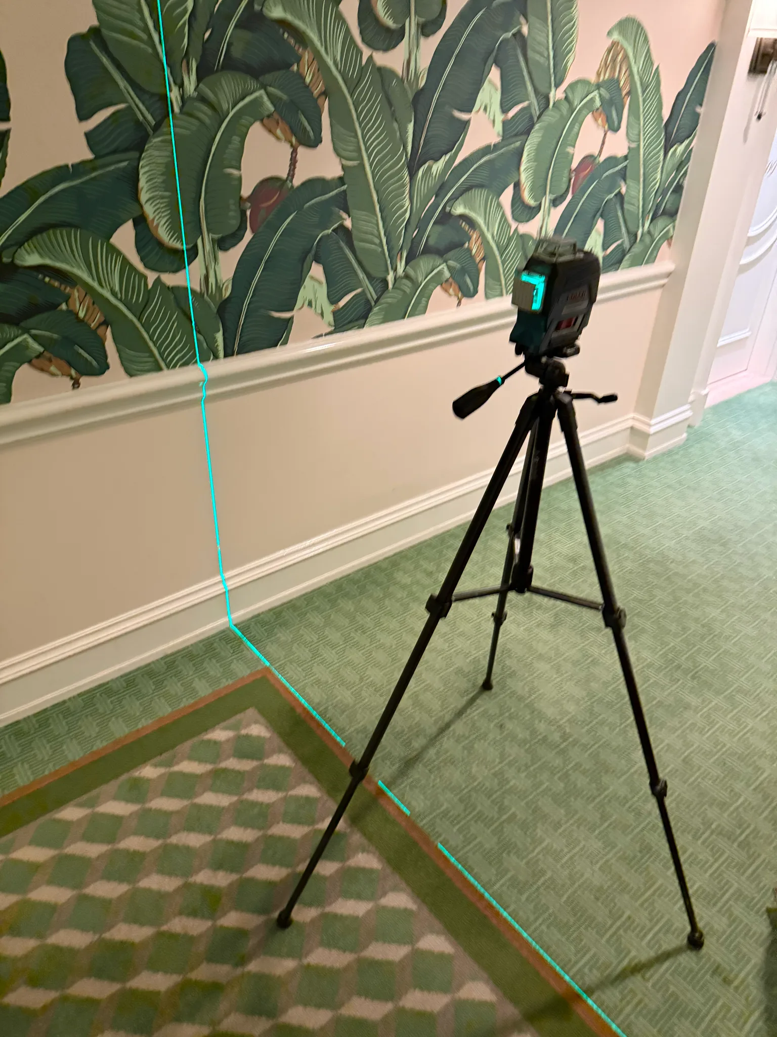 Work in progress: laser level aligning the geometric corridor carpet at The Beverly Hills Hotel