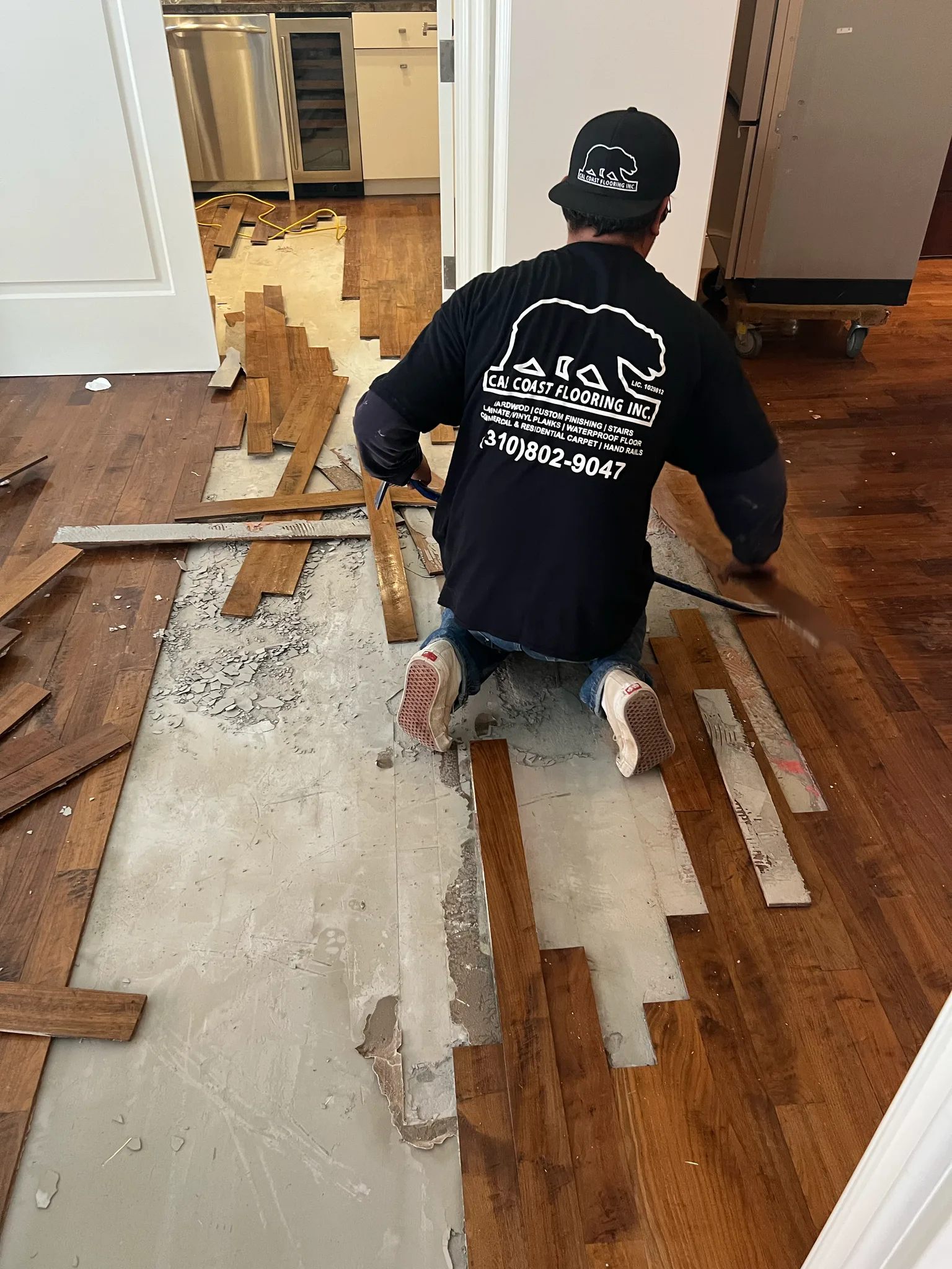 Work in progress: crew weaving replacement hardwood planks into an existing floor at The Beverly Hills Hotel