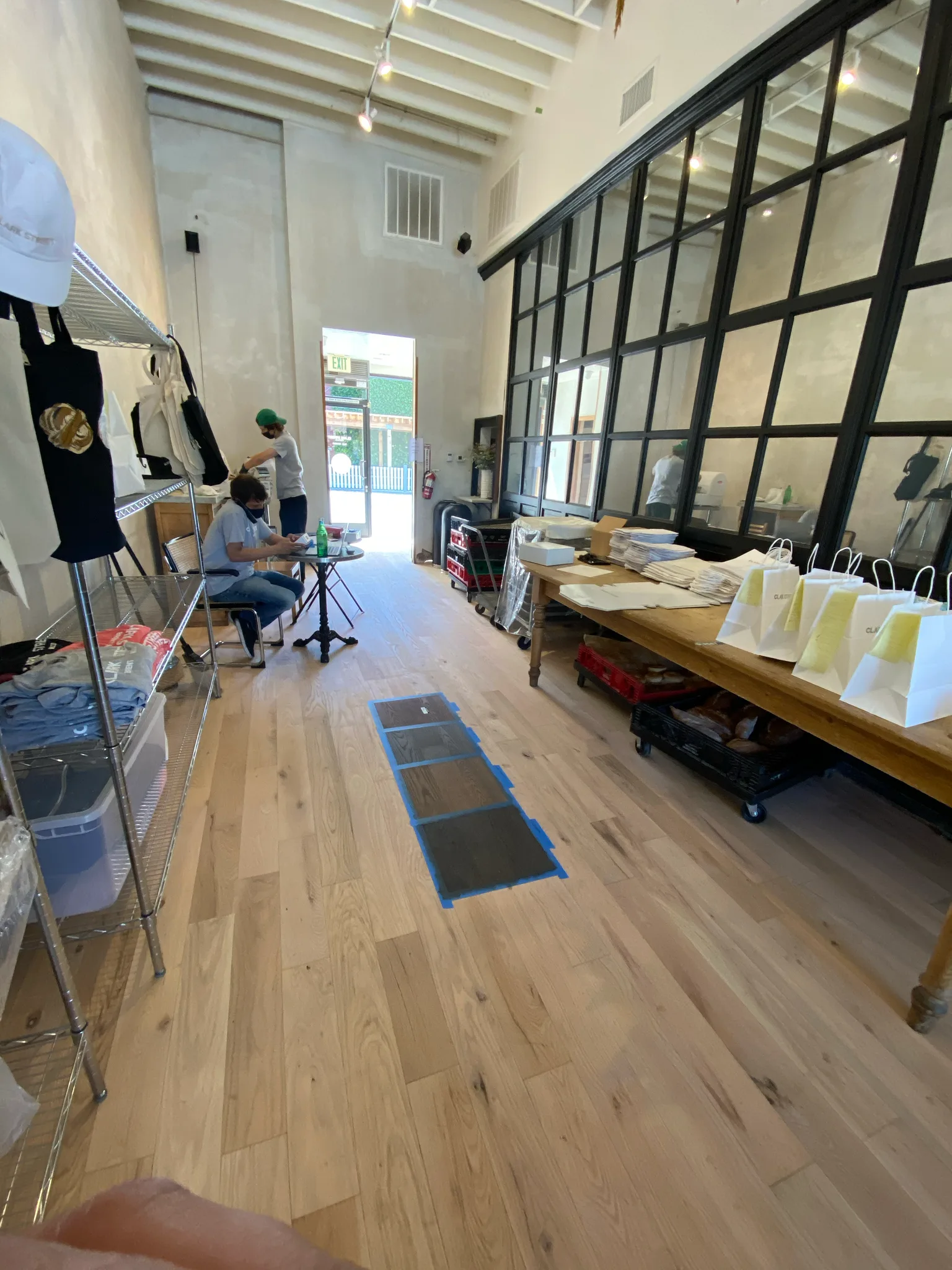 Light wide-plank hardwood floor installed by Cal Coast Flooring across the Clark Street Bakery salesfloor