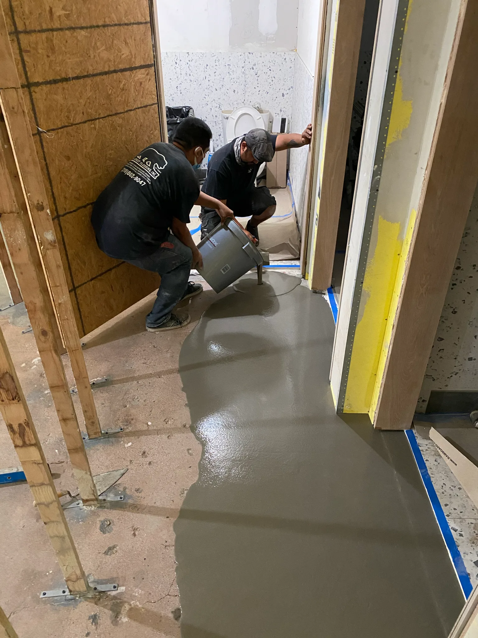 Work in progress: Cal Coast Flooring crew pouring self-leveling underlayment at Esperanza