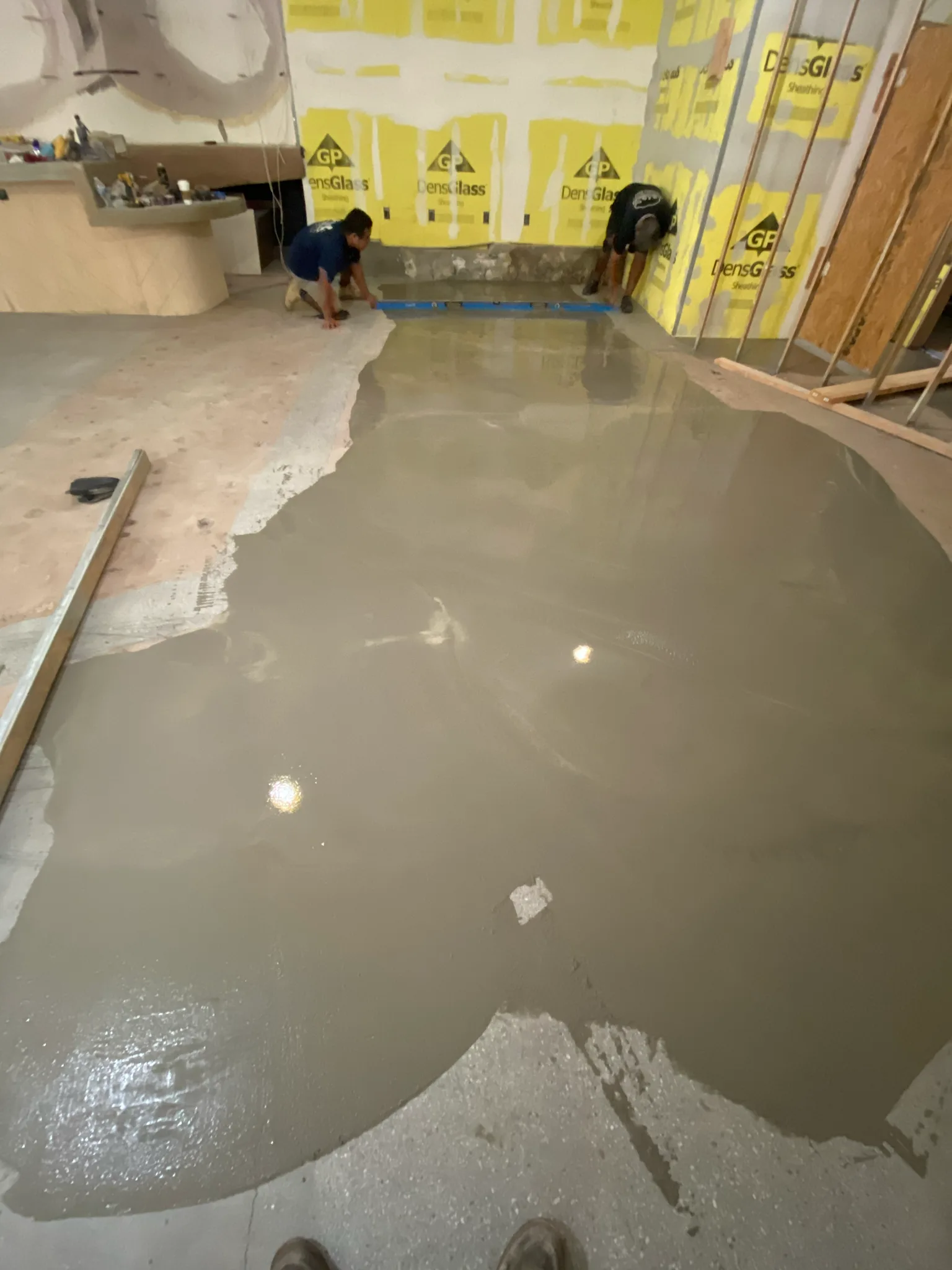 Work in progress: self-leveling underlayment spread across the Esperanza subfloor by Cal Coast Flooring