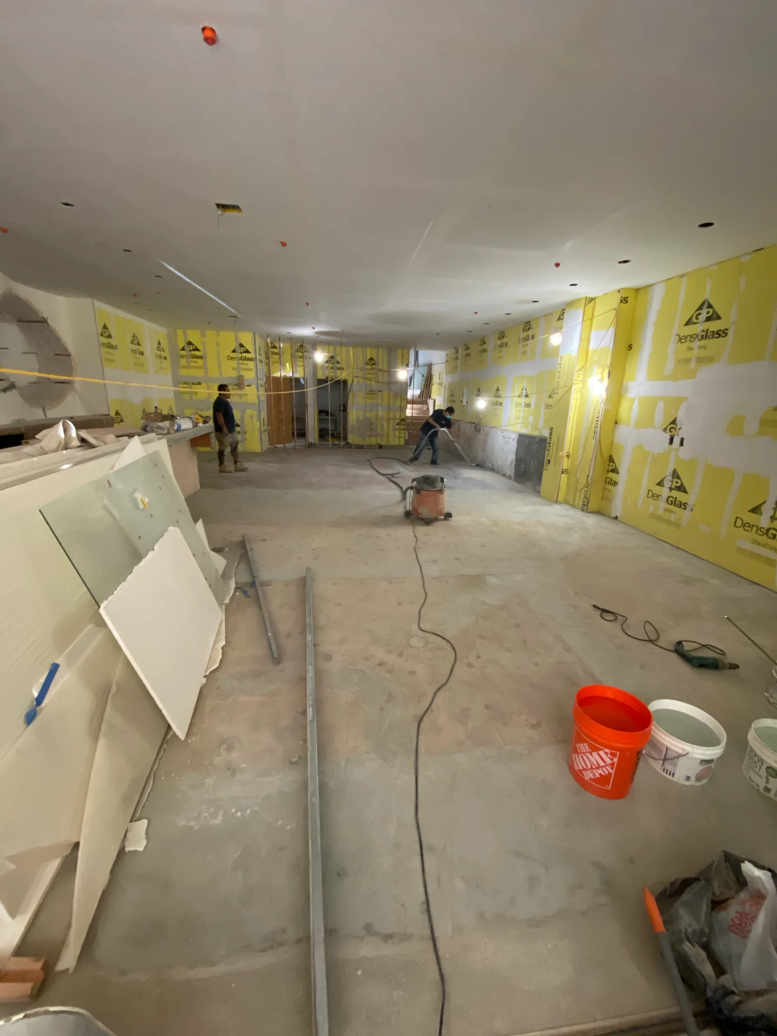 Work in progress: Cal Coast Flooring prepping the bare concrete subfloor at Esperanza