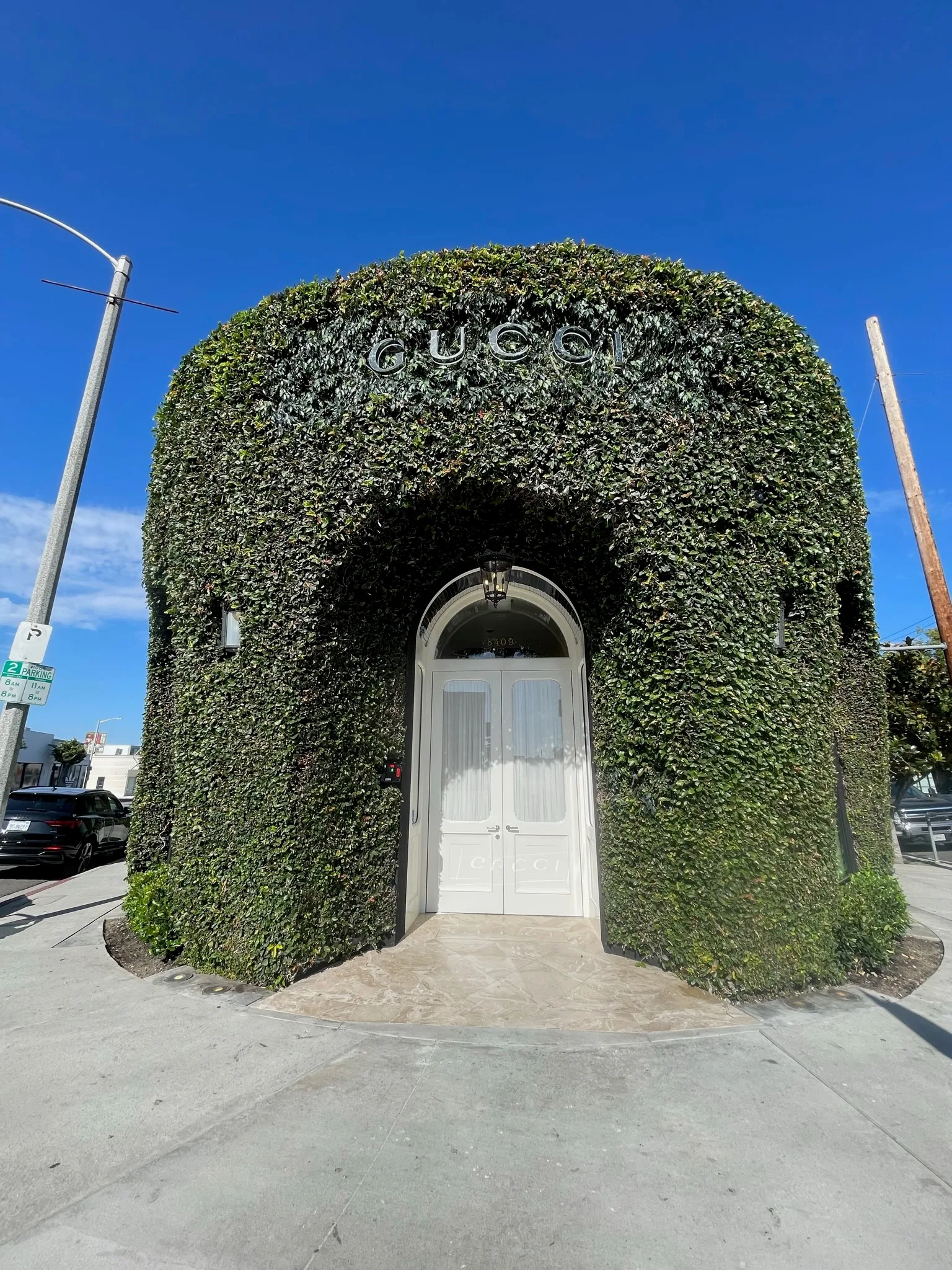 Ivy-covered Gucci storefront on Melrose Place; interior flooring by Cal Coast Flooring