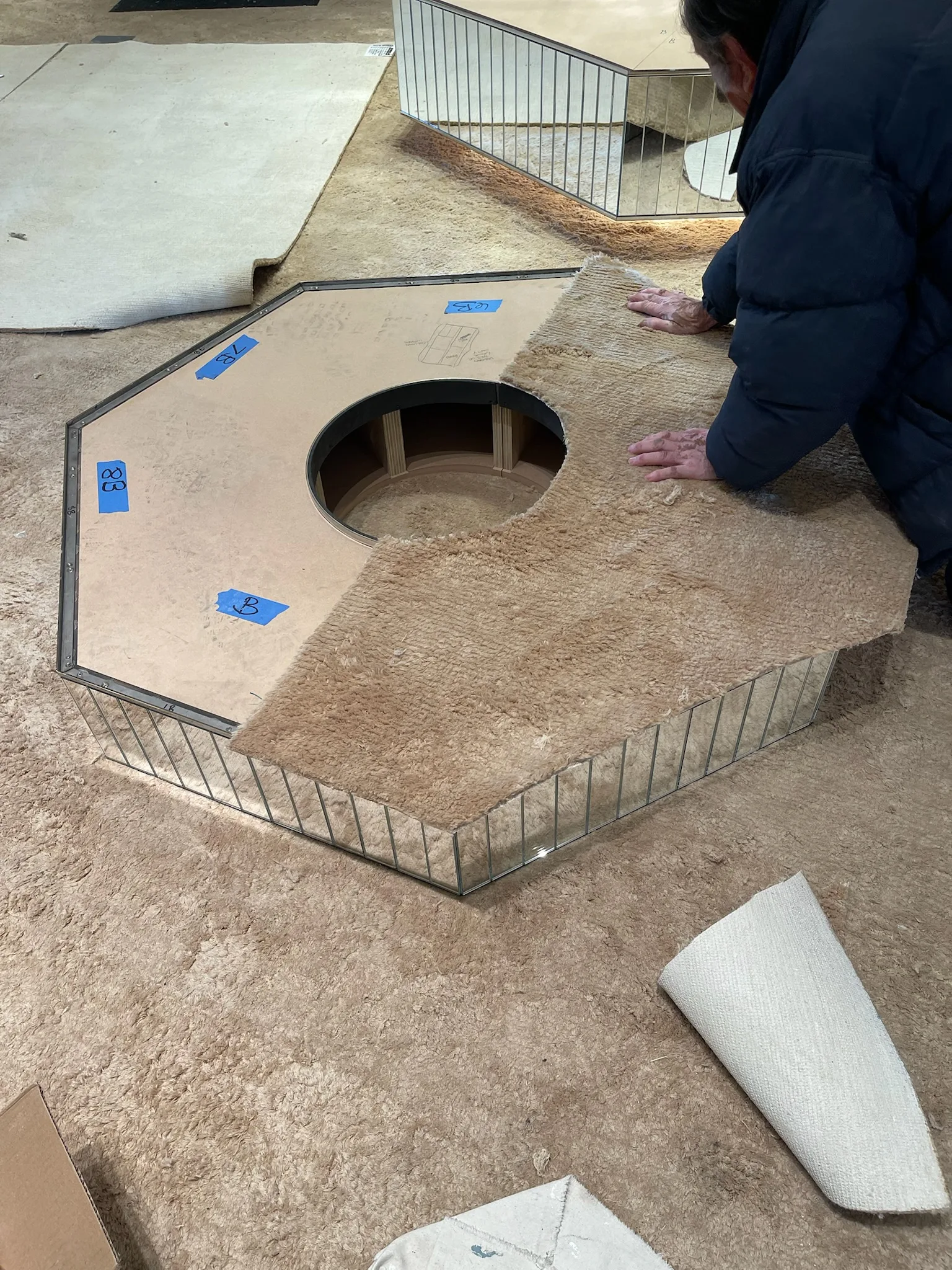 Cal Coast Flooring installer fitting carpet to a display plinth at Gucci Melrose Place