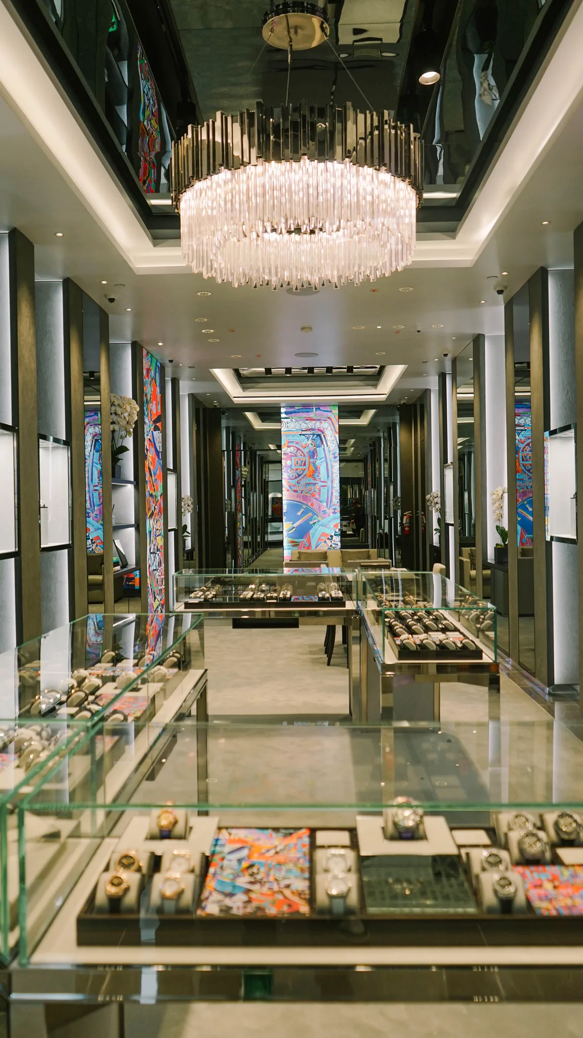 Grey carpet running the length of a Hublot boutique past the glass display cases toward the entrance