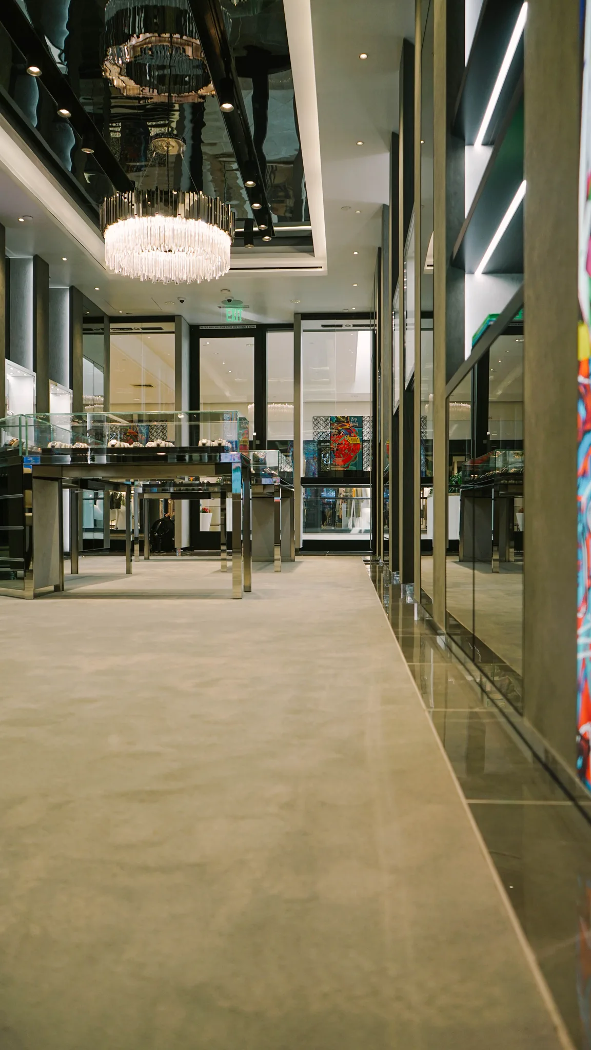 Grey carpet meeting a polished stone border along the display wall of a Hublot boutique