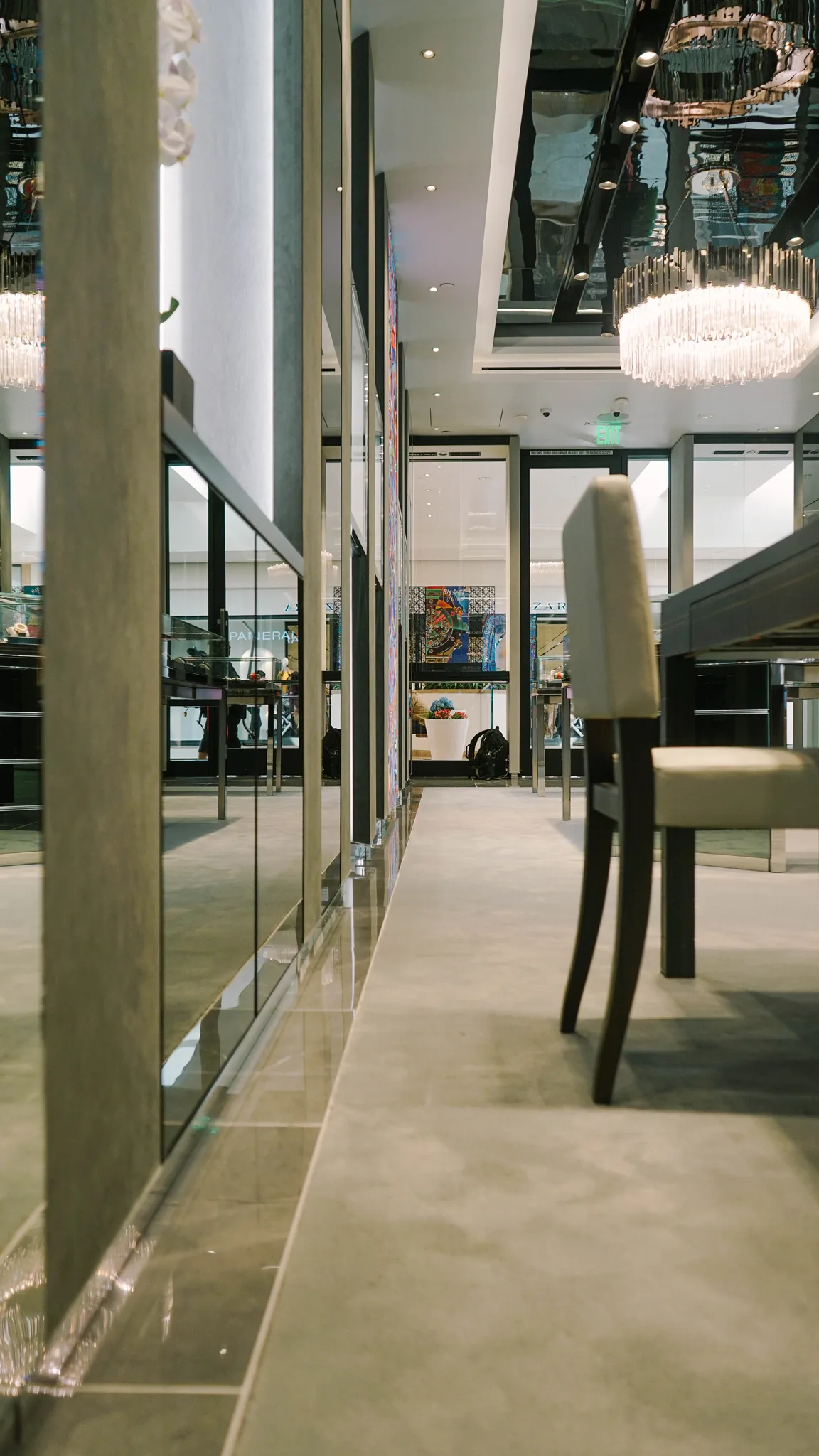 Grey carpet and stone border beside a chair at the watch counter in a Hublot boutique