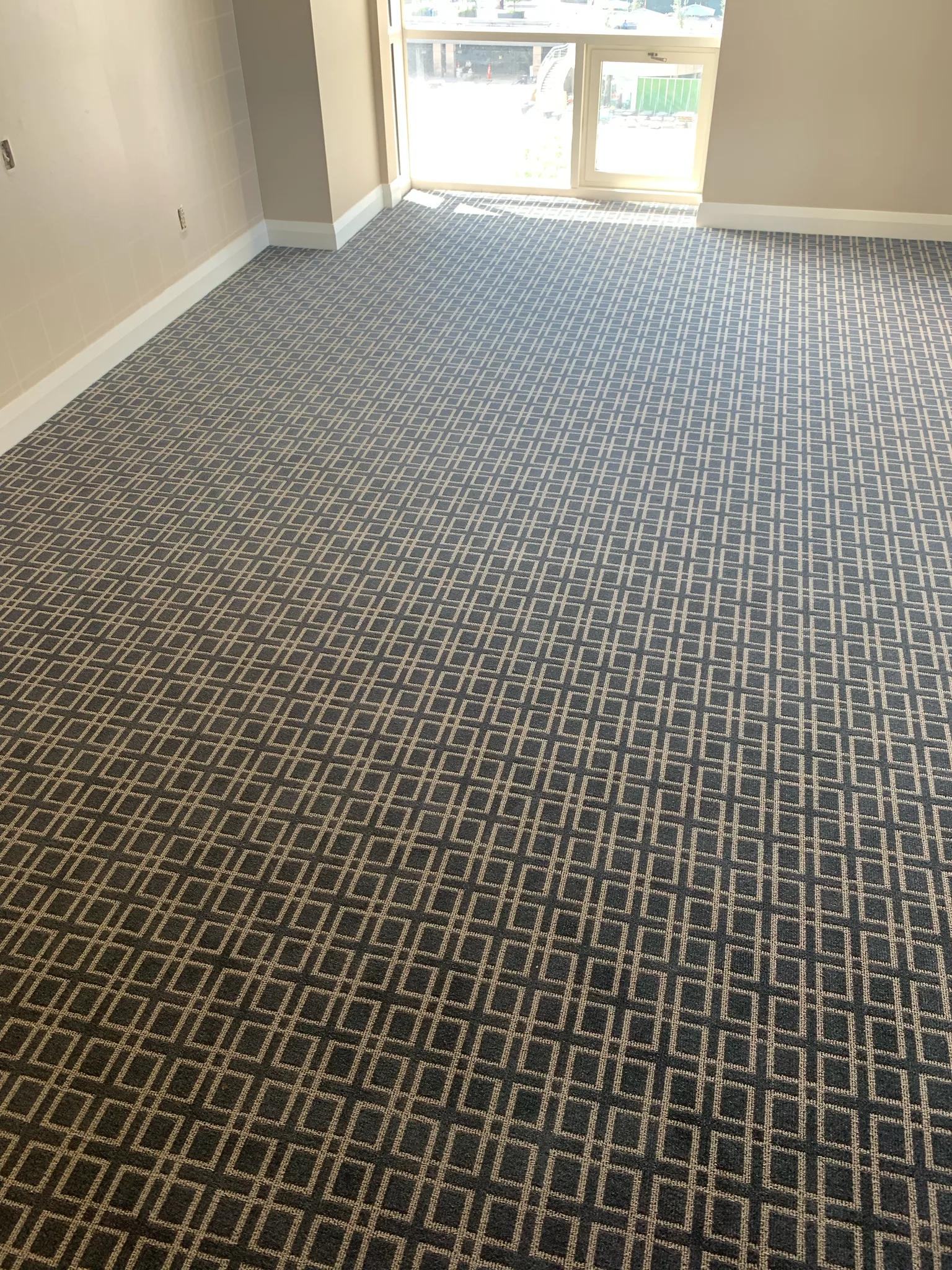 Wall-to-wall geometric carpet installed by Cal Coast Flooring in a guest room at Omni Los Angeles