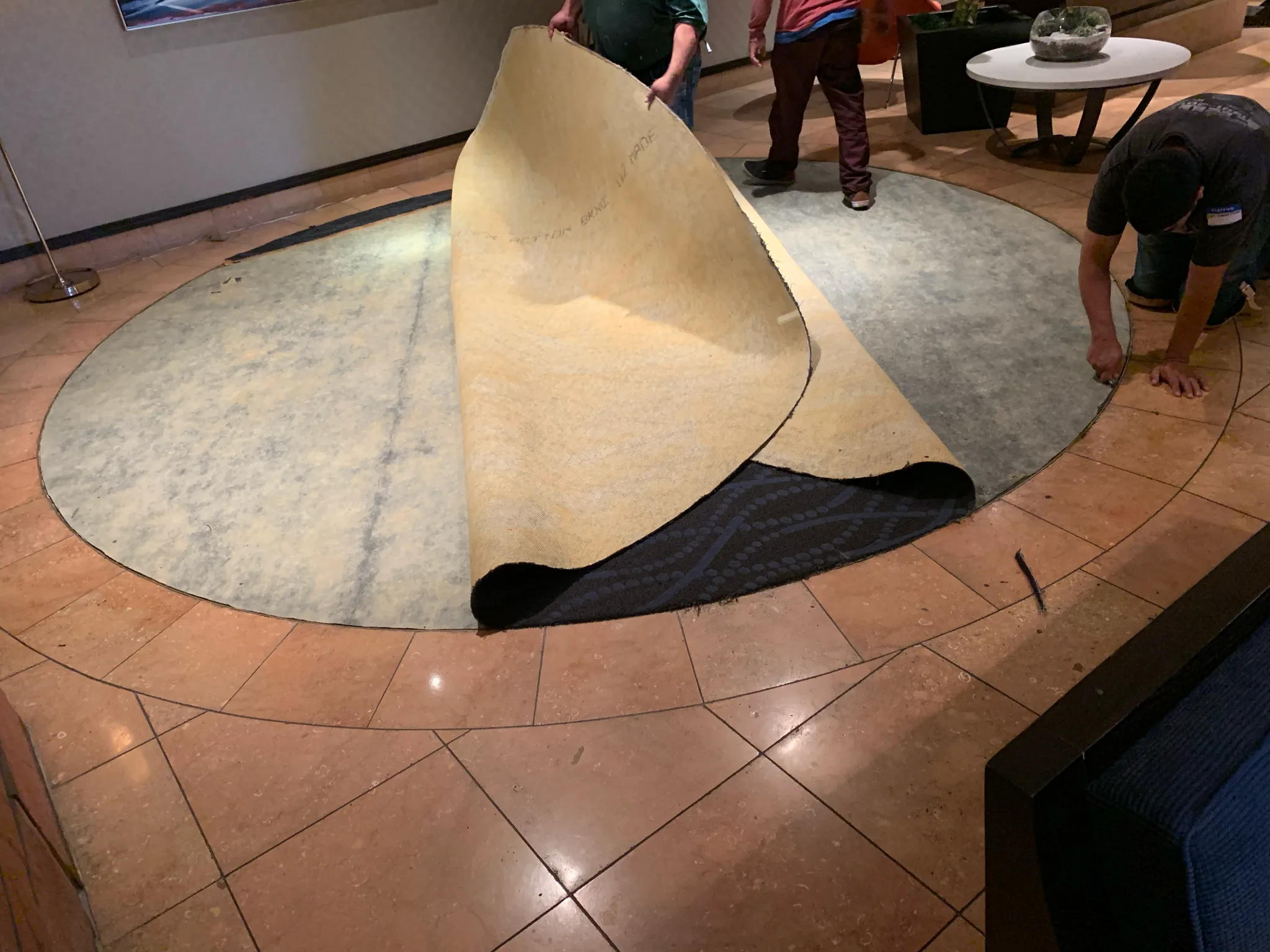 Work in progress: Cal Coast Flooring crew replacing the circular lobby rug inlay in stone tile at Omni Los Angeles