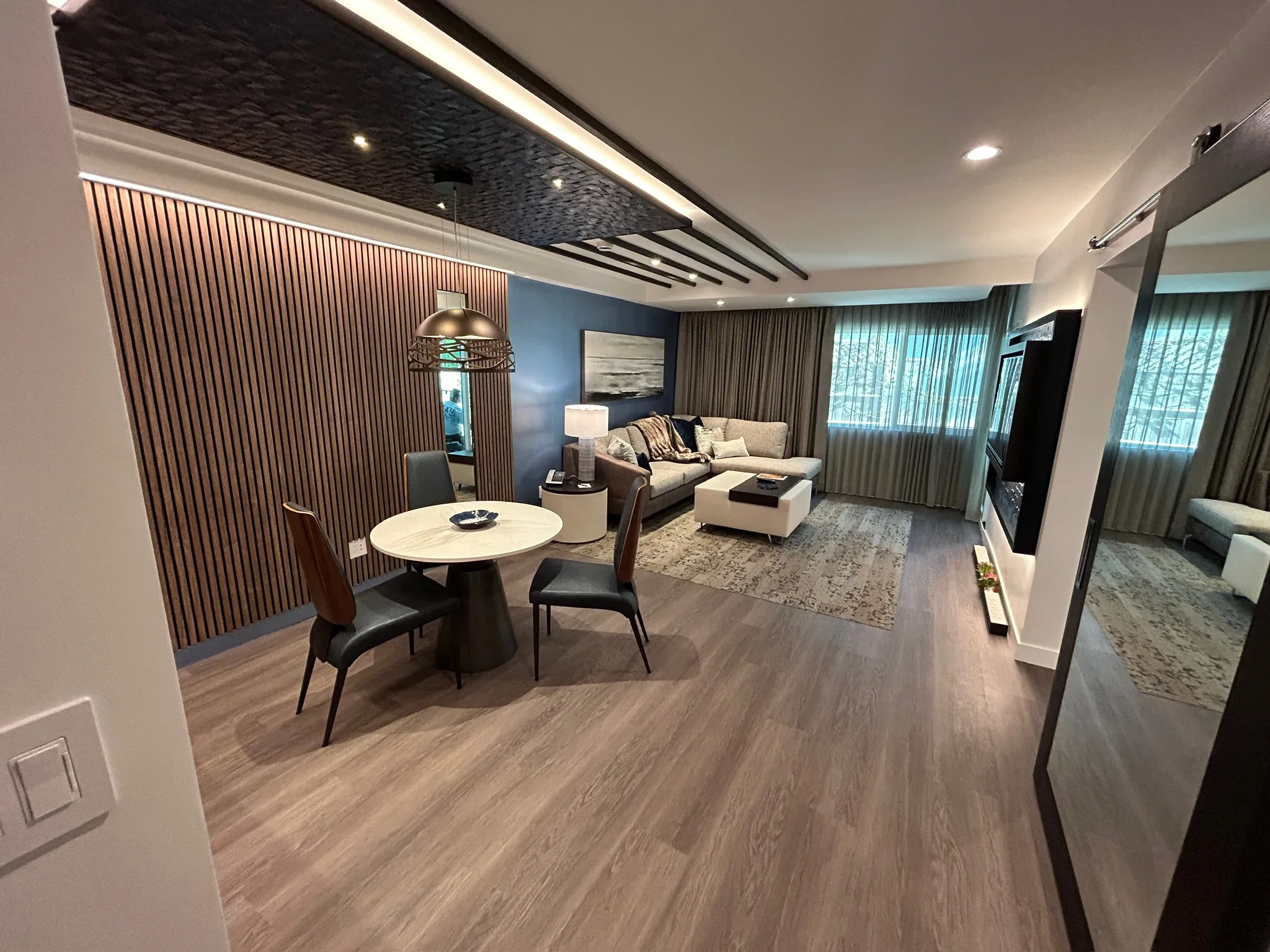 Finished Sunset Marquis hotel suite in West Hollywood with gray wood-look plank flooring installed by Cal Coast Flooring